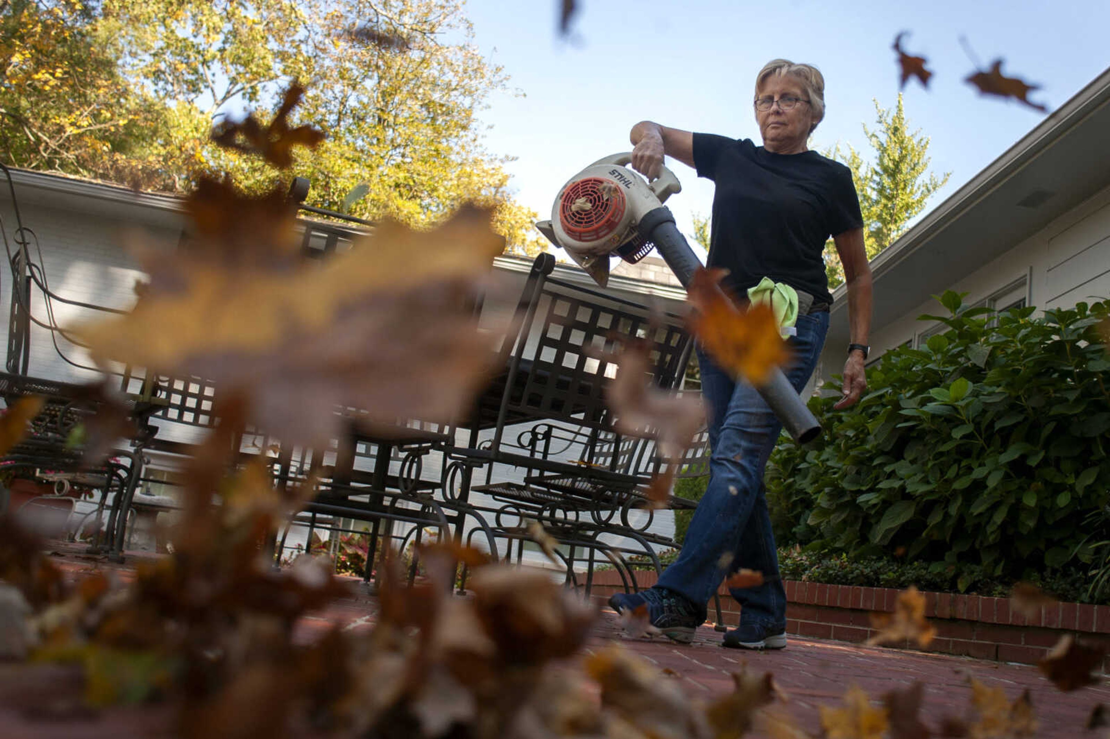 NormaJean Lauck of Apple Creek, Missouri, clears leaves Tuesday, Oct. 22, 2019, at a home on Brookwood Drive in Cape Girardeau. Lauck said she clears leaves at the home about once a week this time of year.