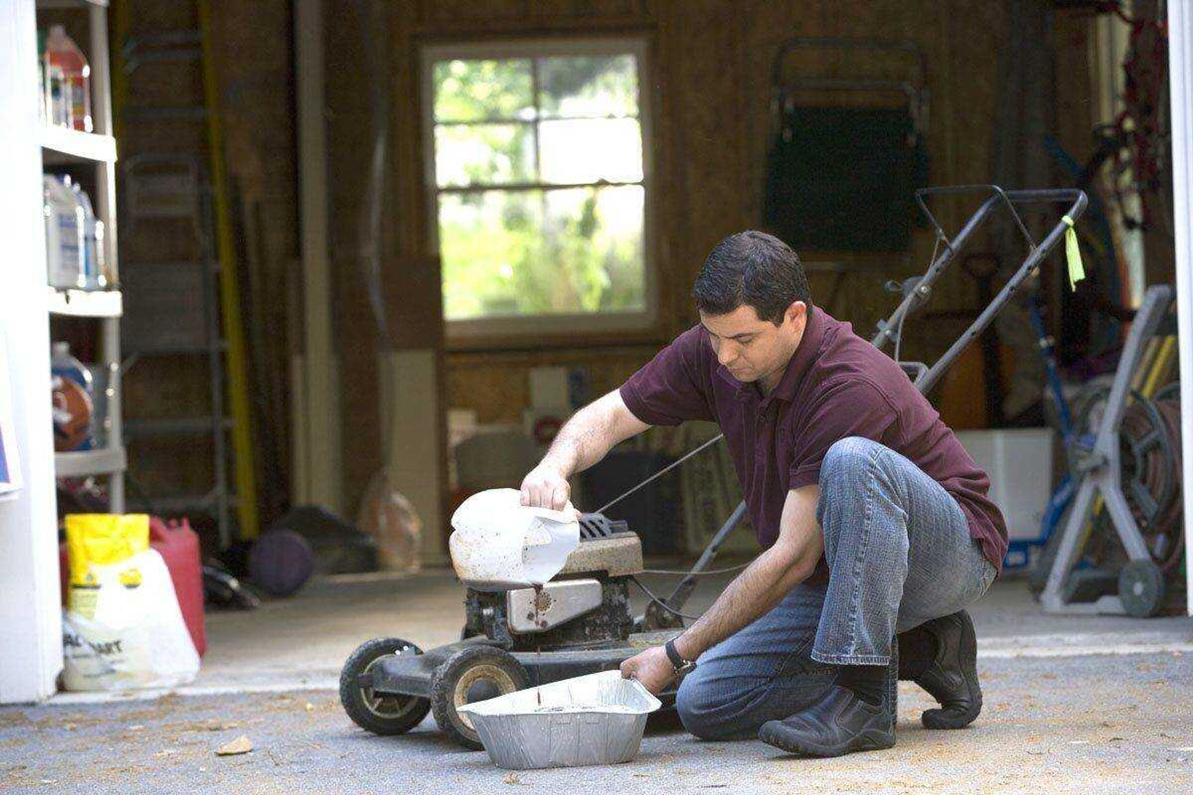 This man was in the process of changing his lawnmower&#180;s oil, using a disposable aluminum catch pan that was filled with absorbent cat litter, both of which can be discarded in a safe, eco-friendly manner. (Cade Martin ~ CDC)