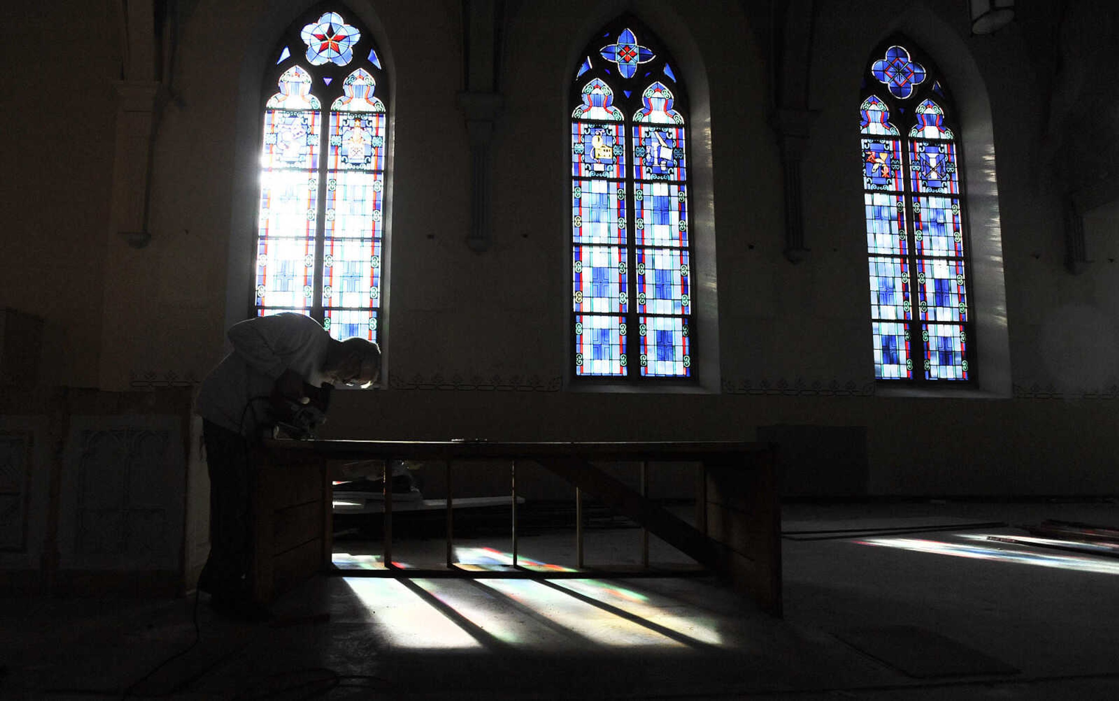 LAURA SIMON ~ lsimon@semissourian.com

Nick Elfrink trims the base of an altar inside St. John's Catholic Church in Leopold, Missouri on Feb. 11, 2016. Elfrink and his wife Geri repaired and painted the altars inside the church. .