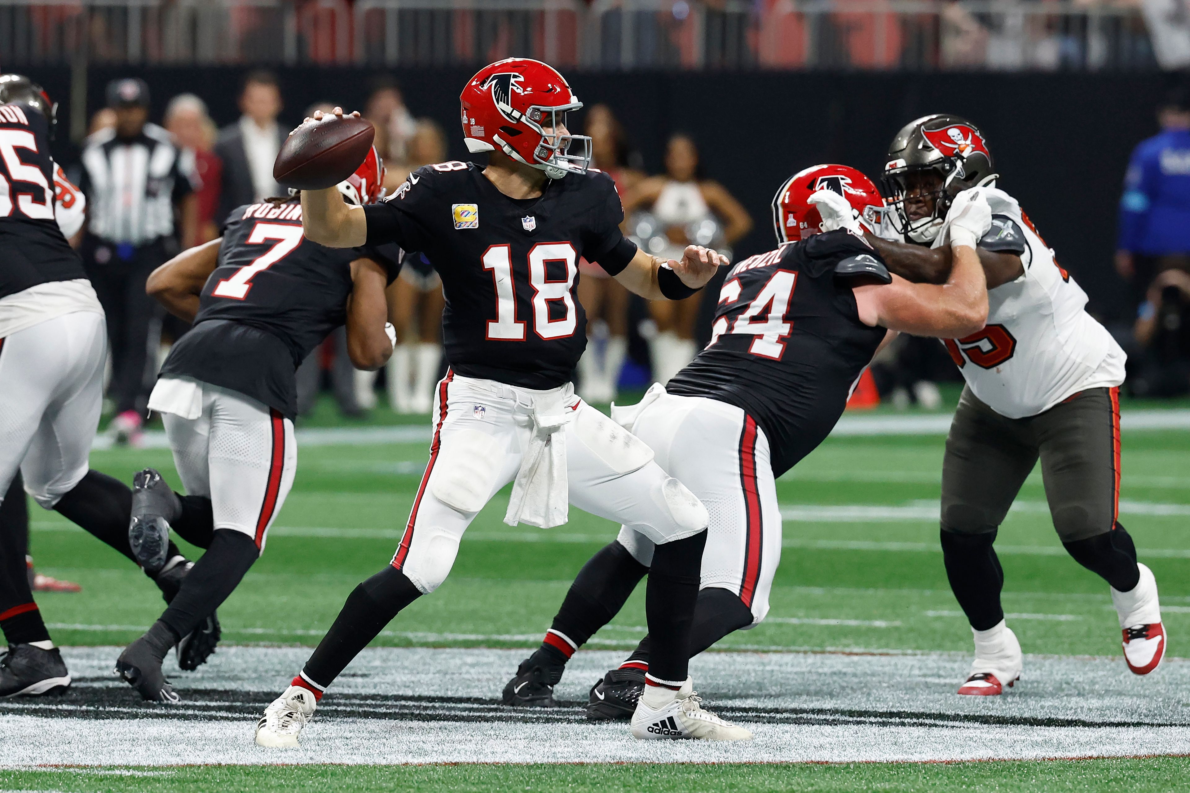 Atlanta Falcons quarterback Kirk Cousins (18) throws the game-wining touchdown pass to wide receiver KhaDarel Hodge (12) against the Tampa Bay Buccaneers during overtime in an NFL football game Thursday, Oct. 3, 2024, in Atlanta. (AP Photo/Butch Dill)