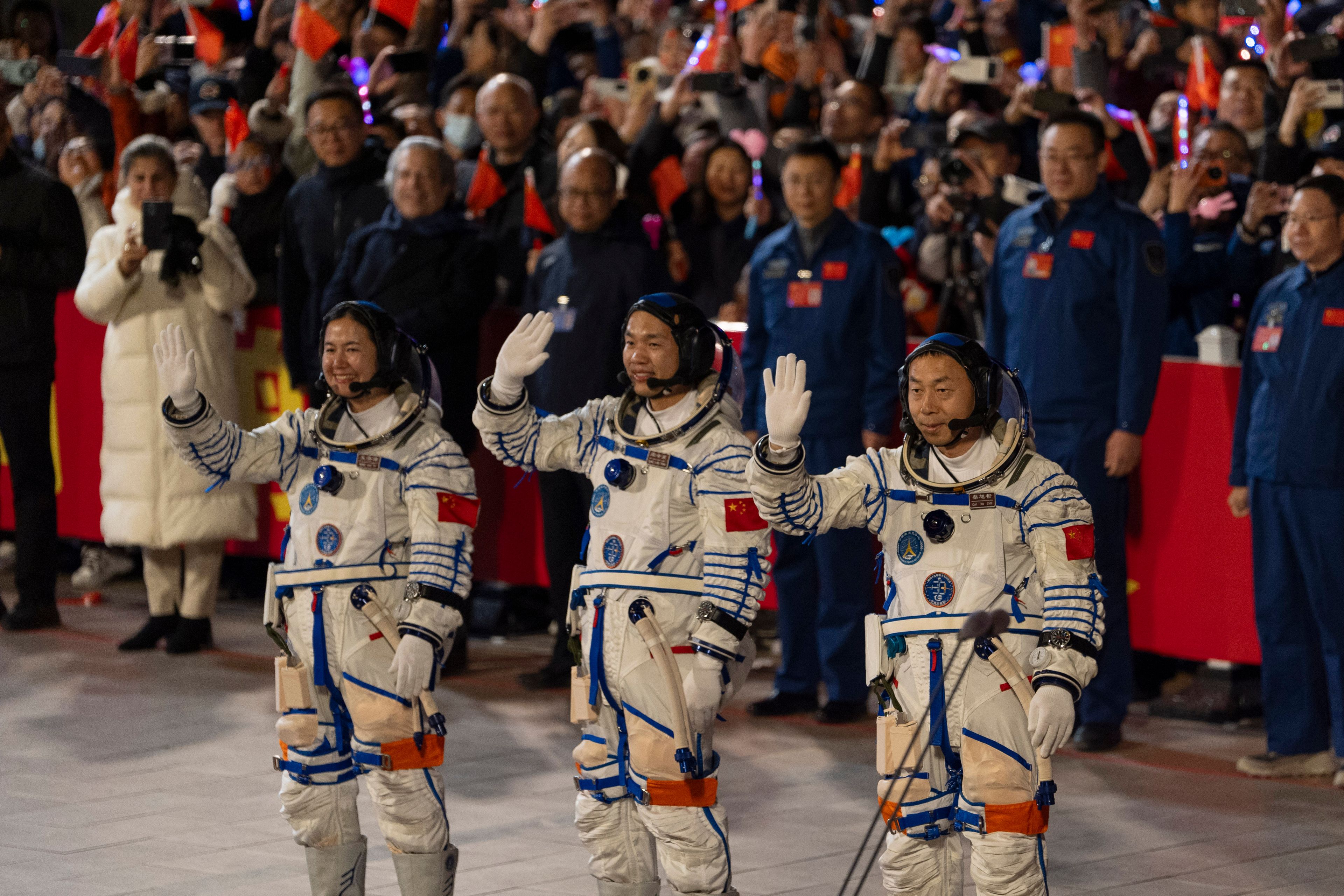 Chinese astronauts Wang Haoze, from left, Song Lingdong and Cai Xuzhe wave during the see-off ceremony for the Shenzhou-19 mission at the Jiuquan Satellite Launch Center in northwestern China, in the early hours of Wednesday, Oct. 30, 2024. (AP Photo/Ng Han Guan)