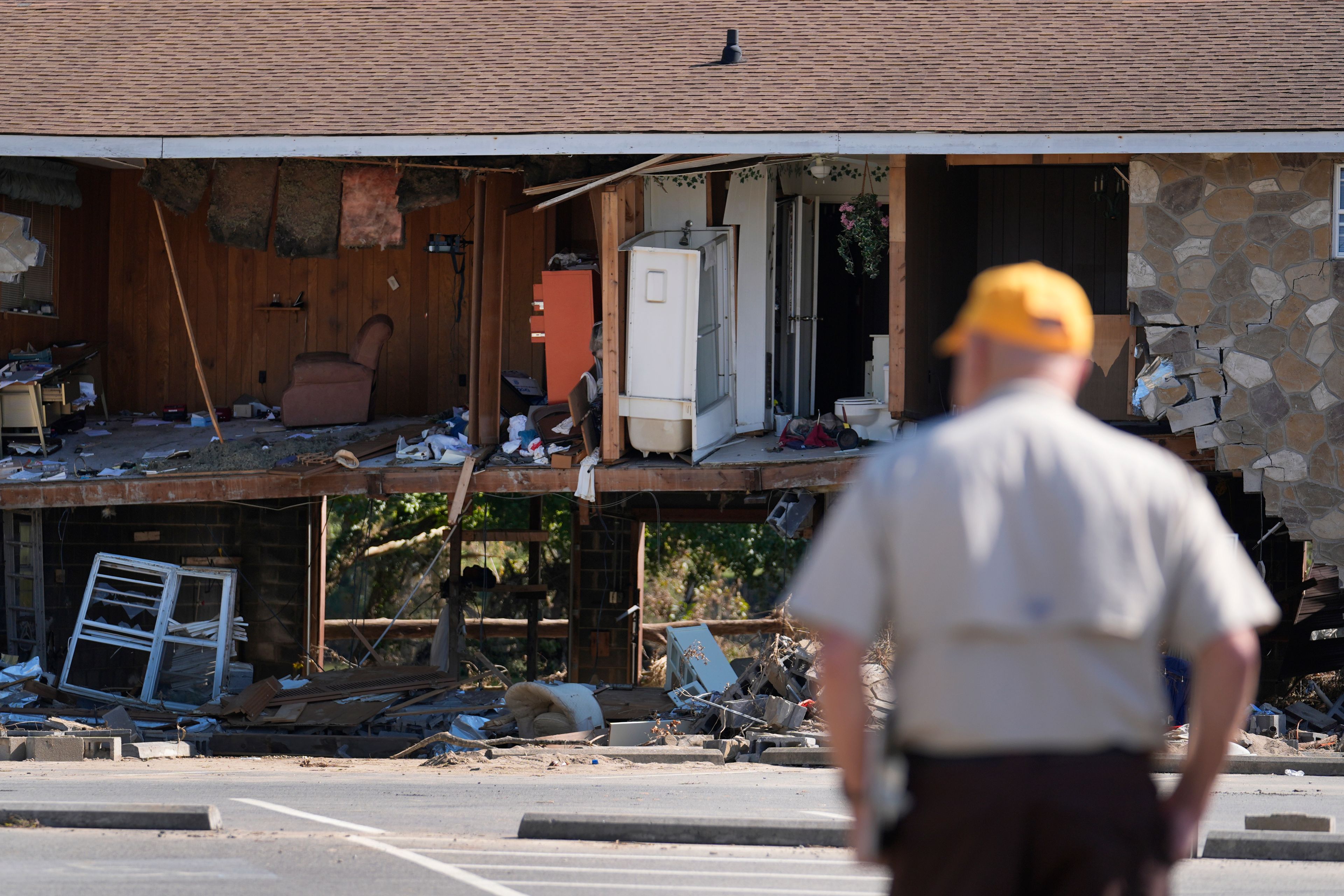 Paul Shaver looks a a building destroyed in the aftermath of Hurricane Helene Saturday, Oct. 5, 2024, in Newport, Tenn. (AP Photo/Jeff Roberson)