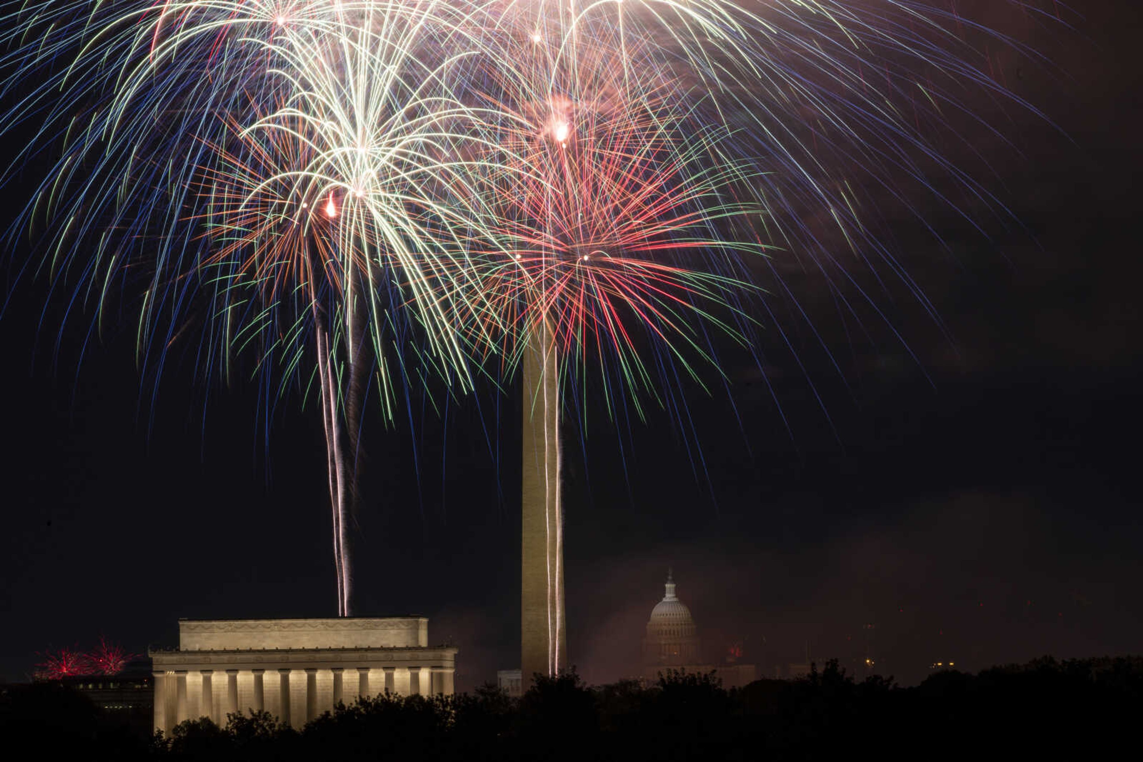 Fireworks burst at the National Mall above the Lincoln Memorial, Washington Monument and the U.S. Capitol building during Independence Day celebrations in Washington, late Tuesday, July 4, 2023. (AP Photo/Stephanie Scarbrough)