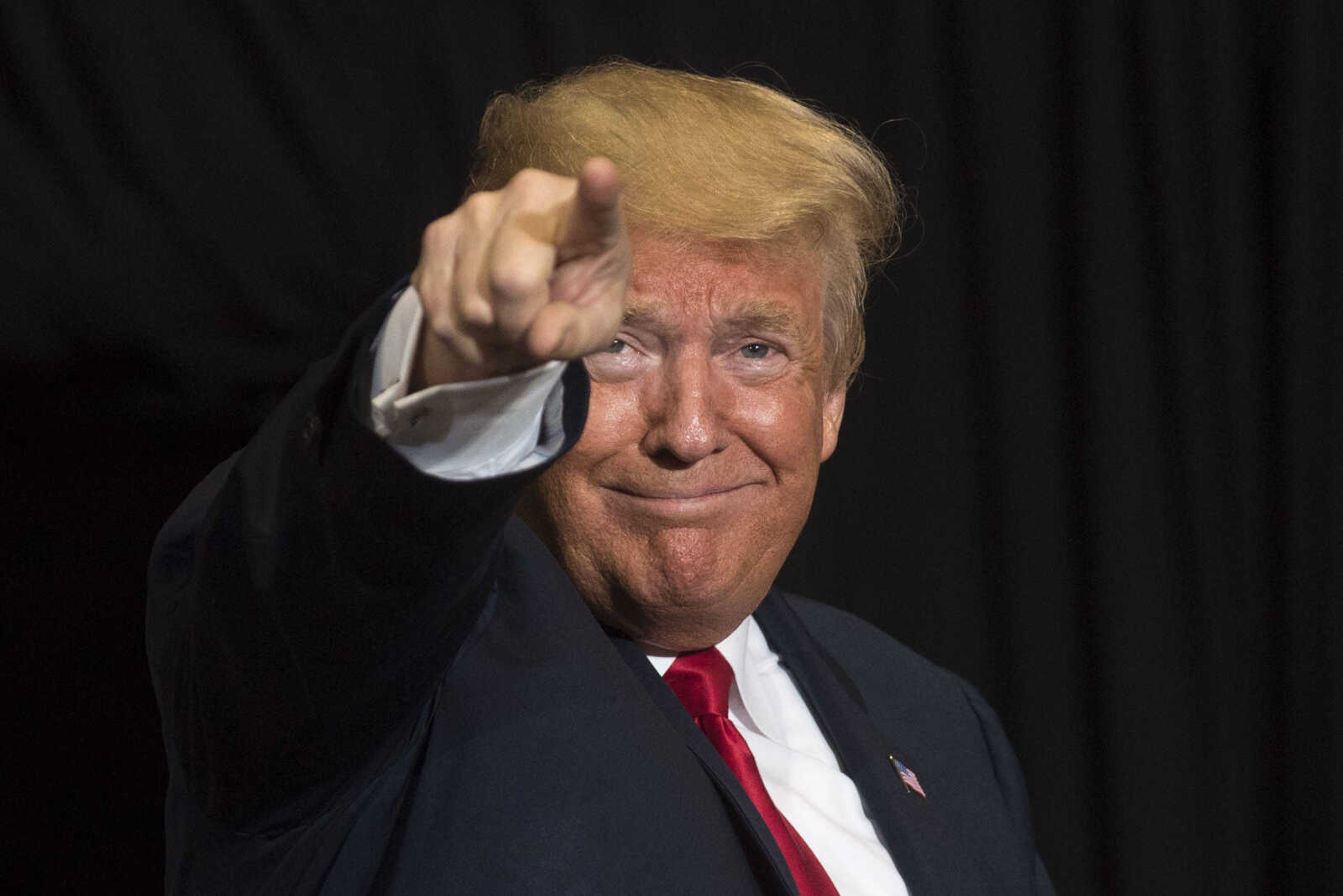 President Donald Trump points to members of the audience as he takes the stage during a Make America Great Again rally Monday, Nov. 5, 2018, at the Show Me Center.