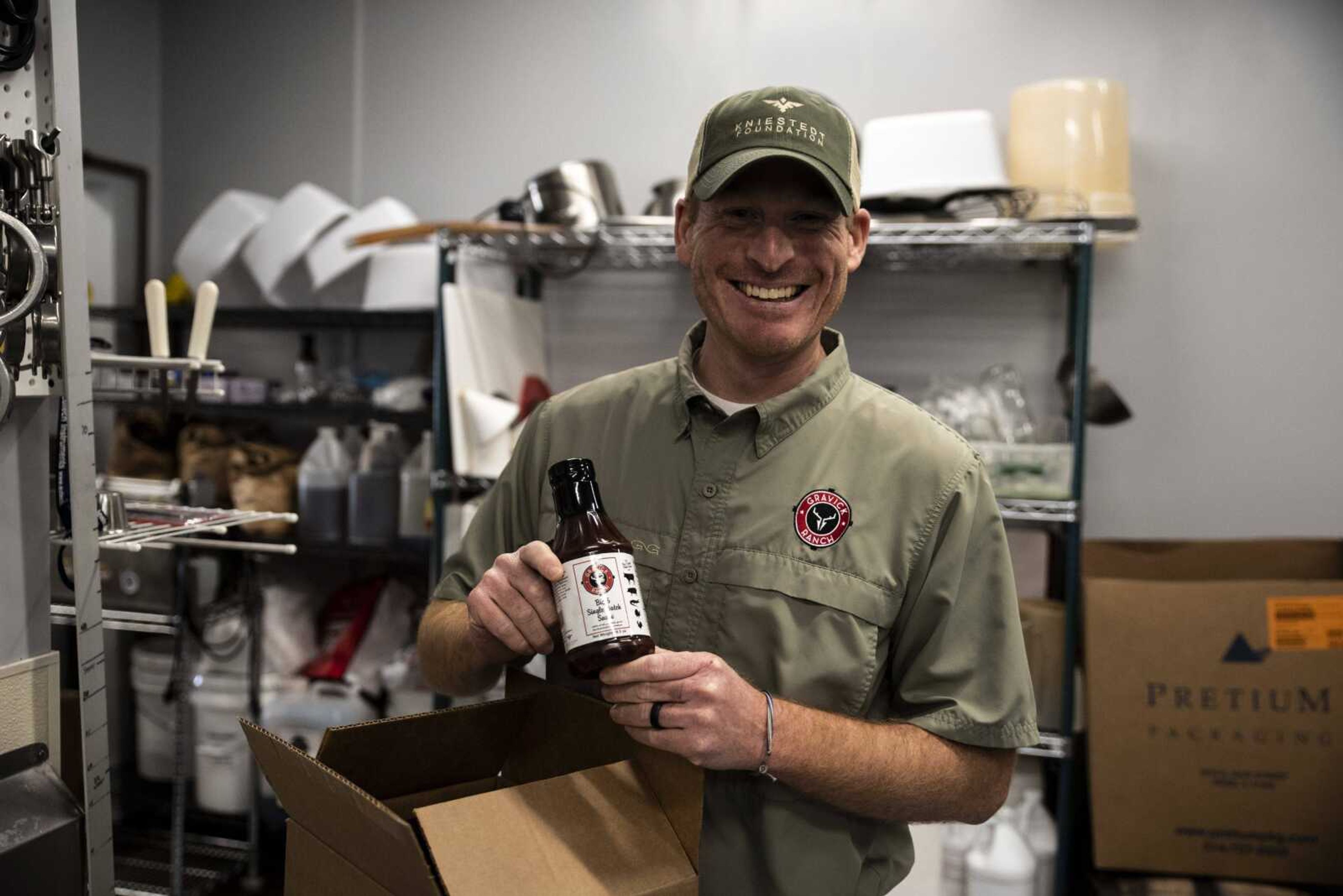 Joe Rhodes holds a bottle of barbecue sauce at Uncle Bob's Spice and Blends in St. Charles, Missouri, where it is made for the Kniestedt Foundation.