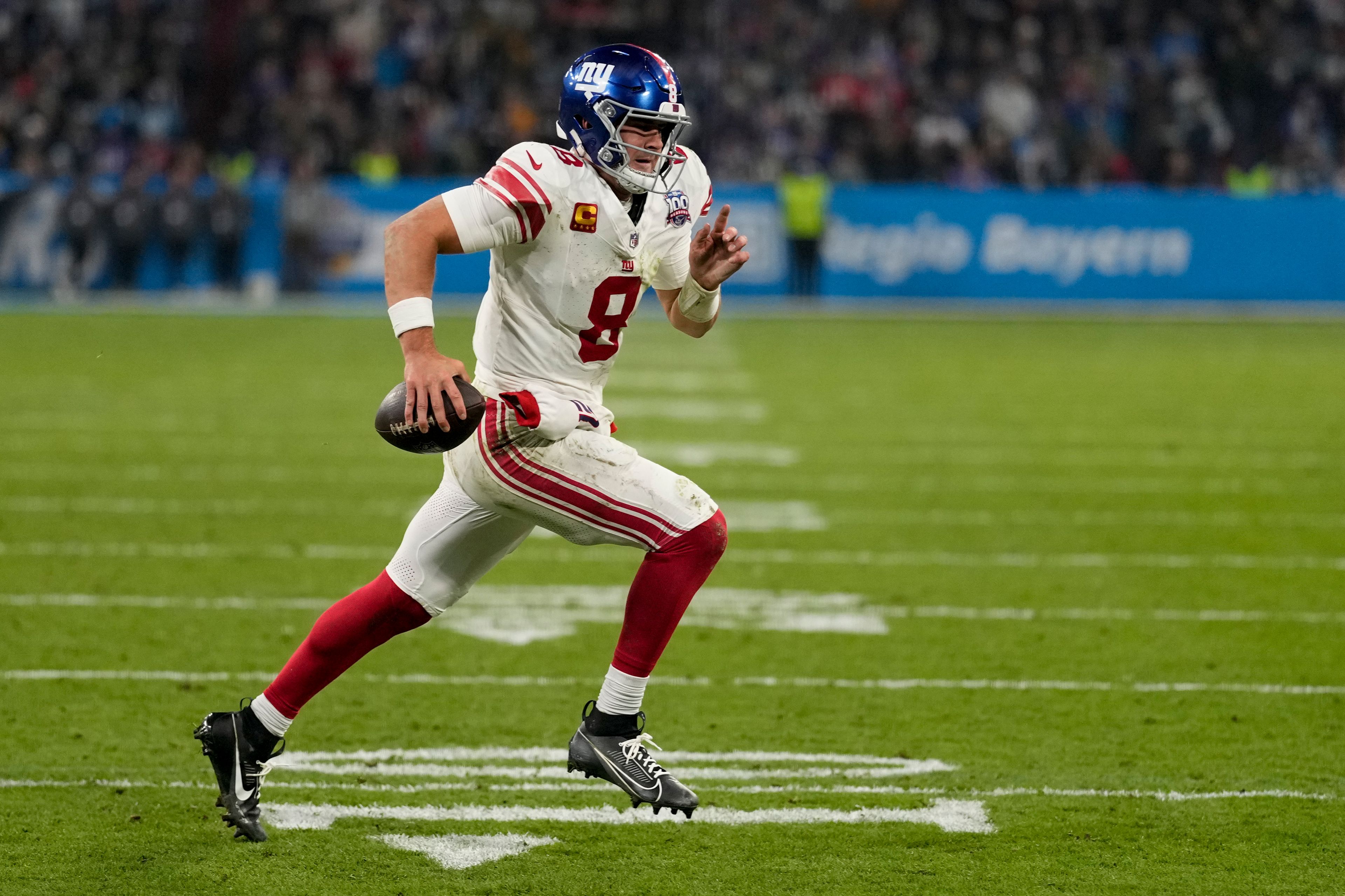 New York Giants quarterback Daniel Jones (8) runs for a touchdown against the Carolina Panthers during the second half of an NFL football game, Sunday, Nov. 10, 2024, in Munich, Germany. (AP Photo/Matthias Schrader)