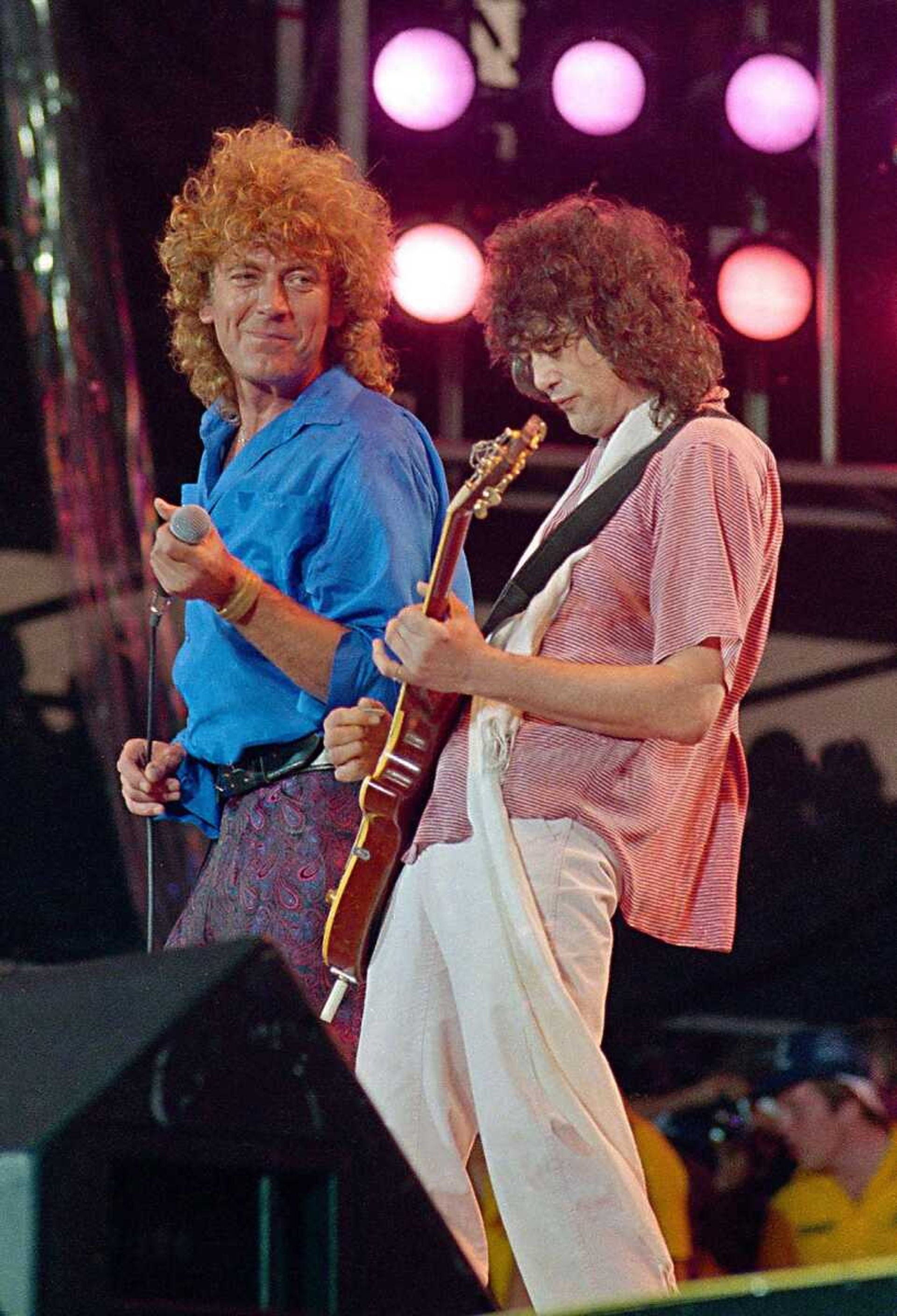 Led Zeppelin bandmates, singer Robert Plant, left, and guitarist Jimmy Page, reunite to perform for the Live Aid famine relief concert at JFK Stadium in Philadelphia Pa., in this July 13, 1985, file photo. (AP Photo/Amy Sancetta, file)