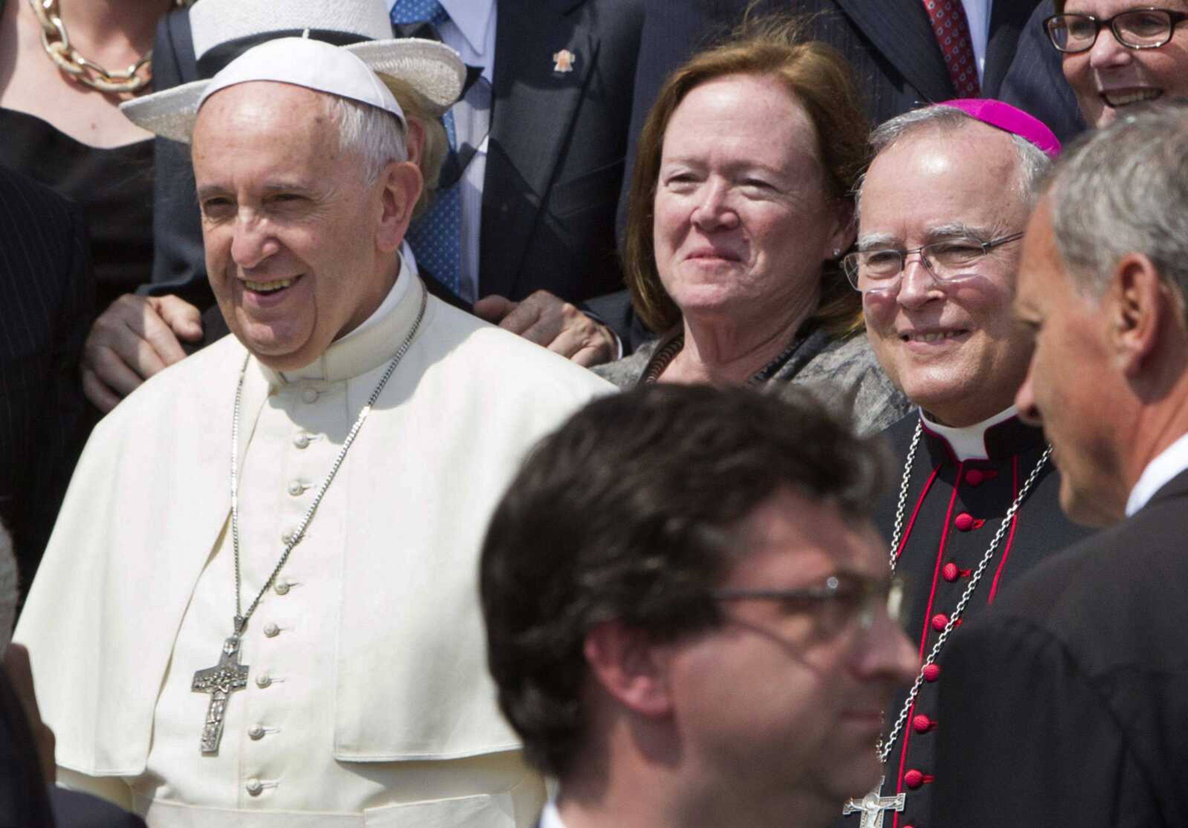 Philadelphia's Archbishop Charles Chaput, right, stands next to Pope Francis as they pose June 24 with a delegation from Philadelphia at the end of the pontiff's weekly general audience in St. Peter's Square at the Vatican. Pope Francis will be traveling to Philadelphia in September to attend the World Meeting of Families. Chaput, the meeting's host, is moving to limit lesbian, gay, bisexual and transgender Roman Catholics as they try to lobby for a broader role in the event. (Riccardo De Luca ~ Associated Press)