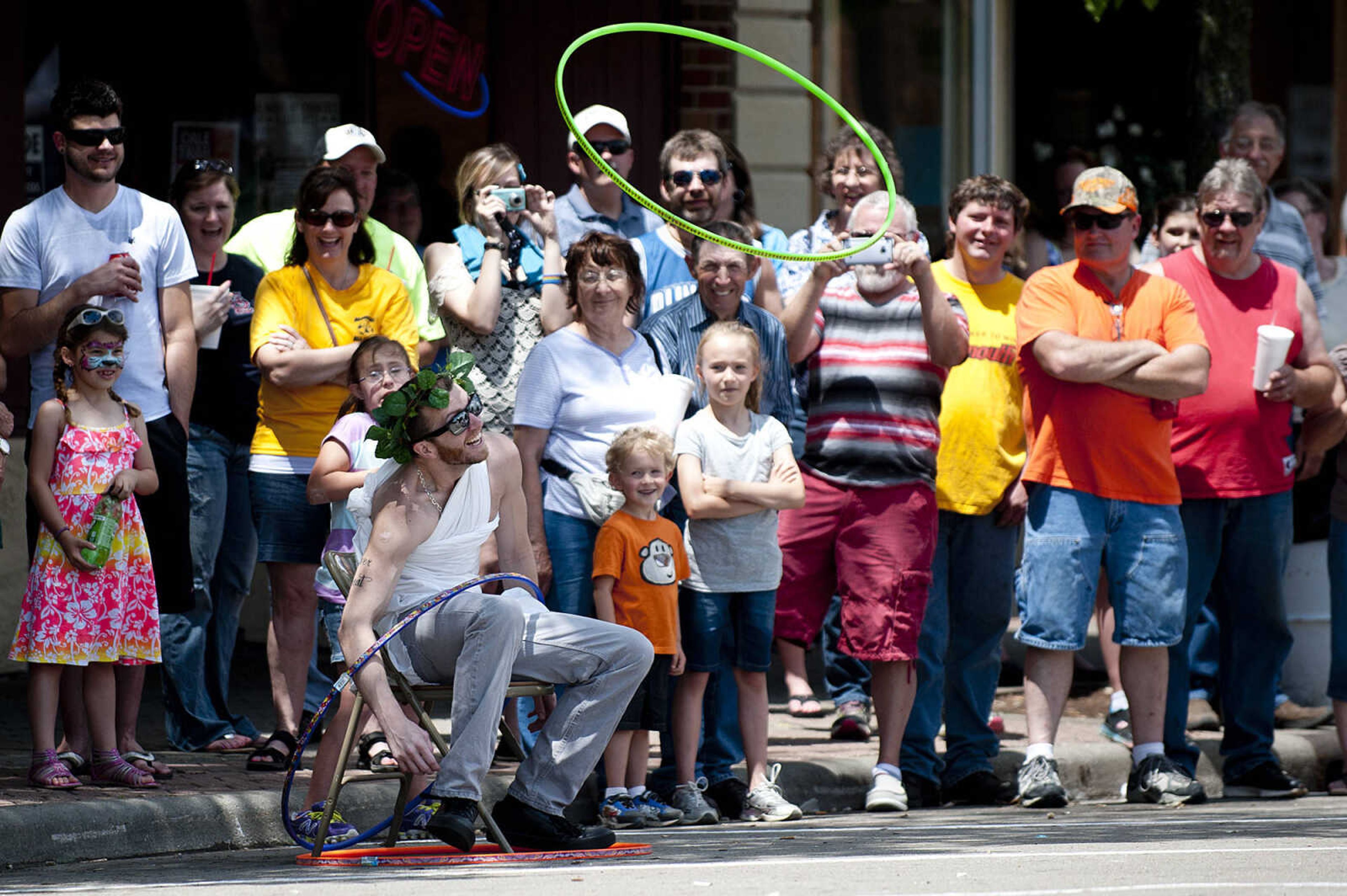 Taylor Old has hulu hoops thrown around him during the first segment of the Perryville Mayfest Bed Races Saturday, May 10, in Perryville, Mo. Reid was a member of the Animal House team sponsored by Mary Jane, Burgers and Brew.