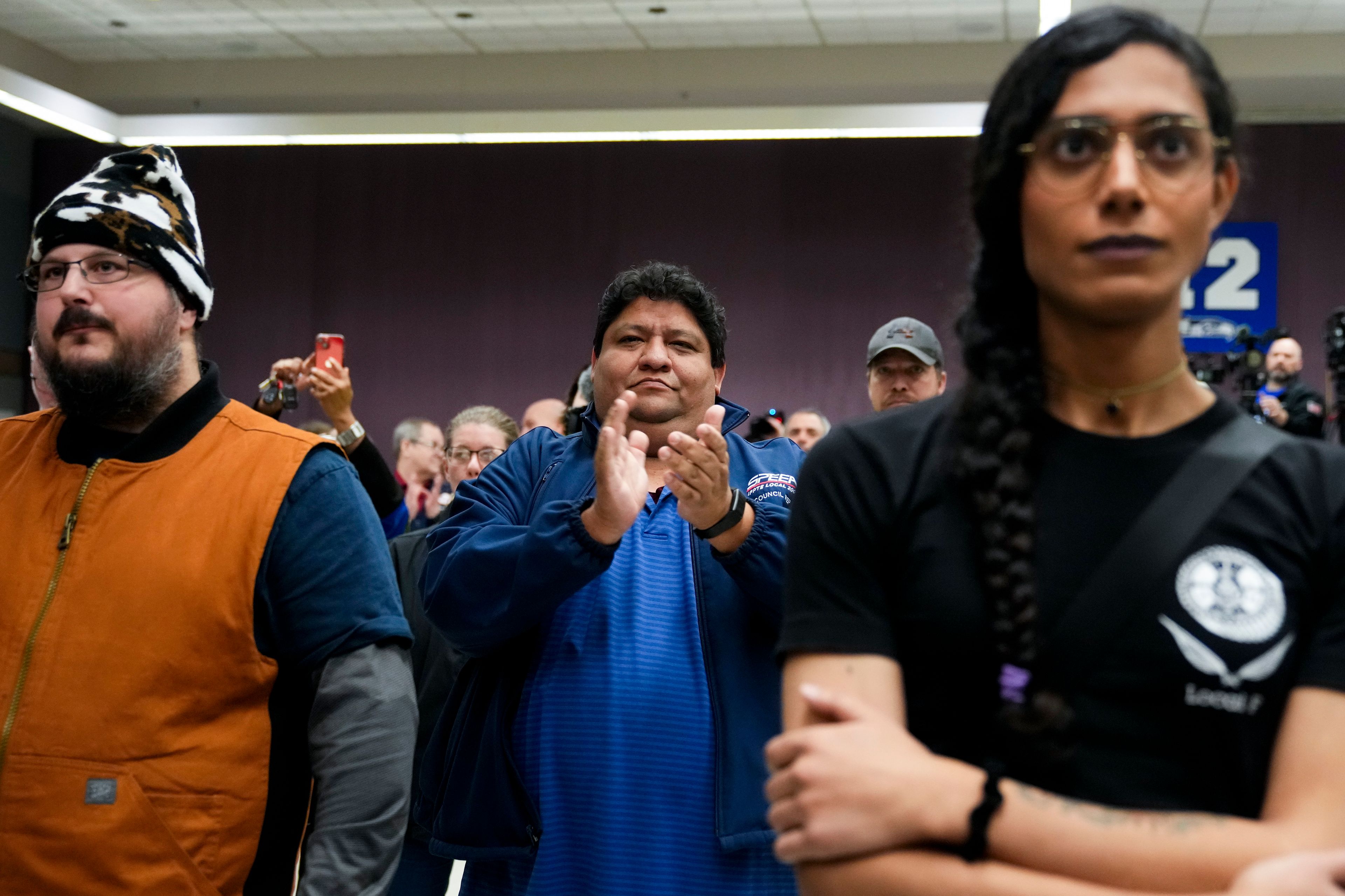 Union members react as IAM District 751 president Jon Holden announces that they voted to accept a new contract offer from Boeing, Monday, Nov. 4, 2024, at their union Hall in Seattle. (AP Photo/Lindsey Wasson)