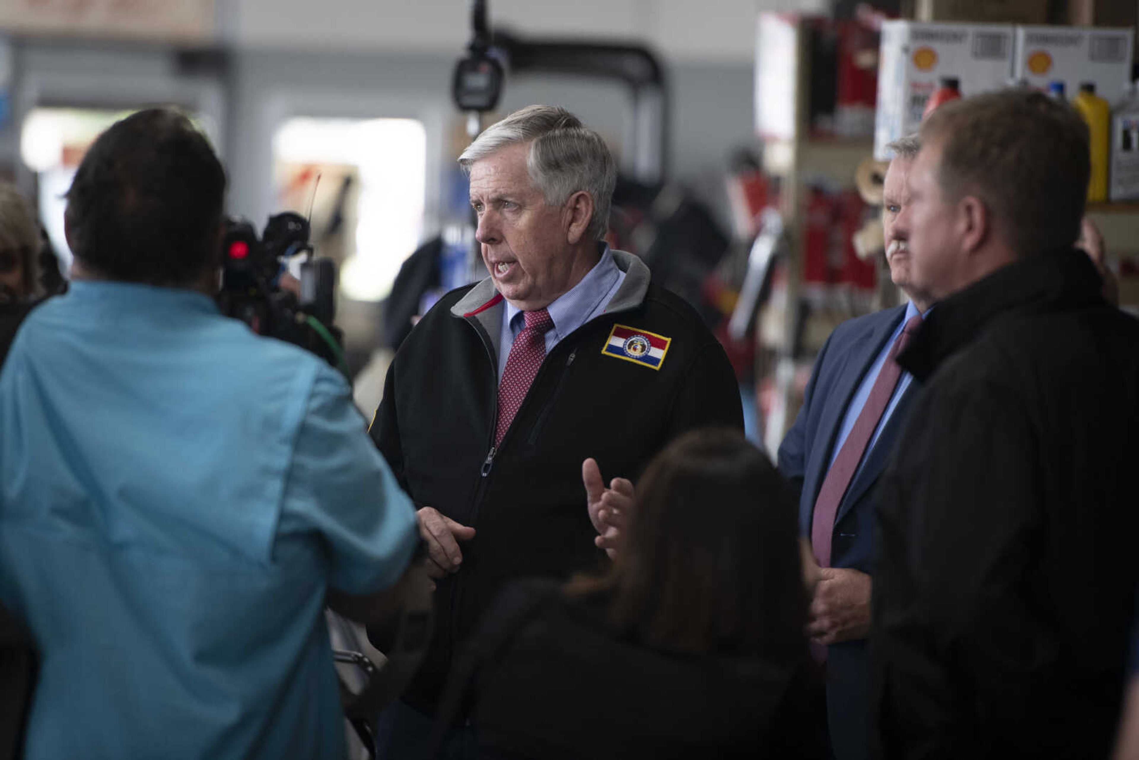 Missouri Gov. Mike Parson, center, speaks while making a visit Thursday, May 14, 2020, at Plaza Tire Service in Cape Girardeau. Following his visit, Gov. Parson returned to Jefferson City for a briefing to give updates on COVID-19 in the state.