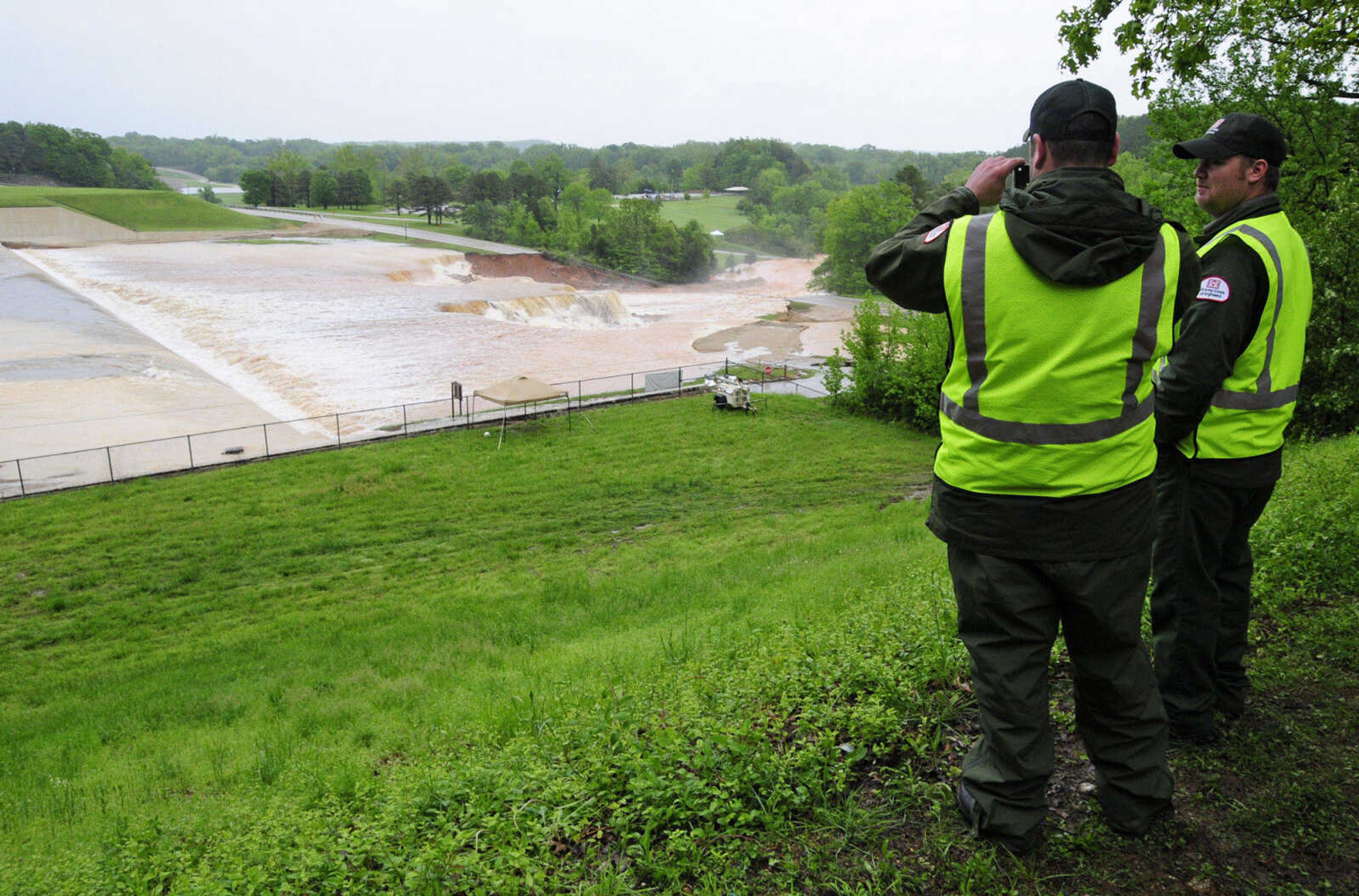 U.S. Army Corps of Engineers personnel watch as Wappapello Lake in Wayne County, Mo., overflows its emergency spillway Monday morning, May 2, 2011, threatening residents downstream on the St. Francis River. (AP Photo/Daily American Republic, Paul Davis)