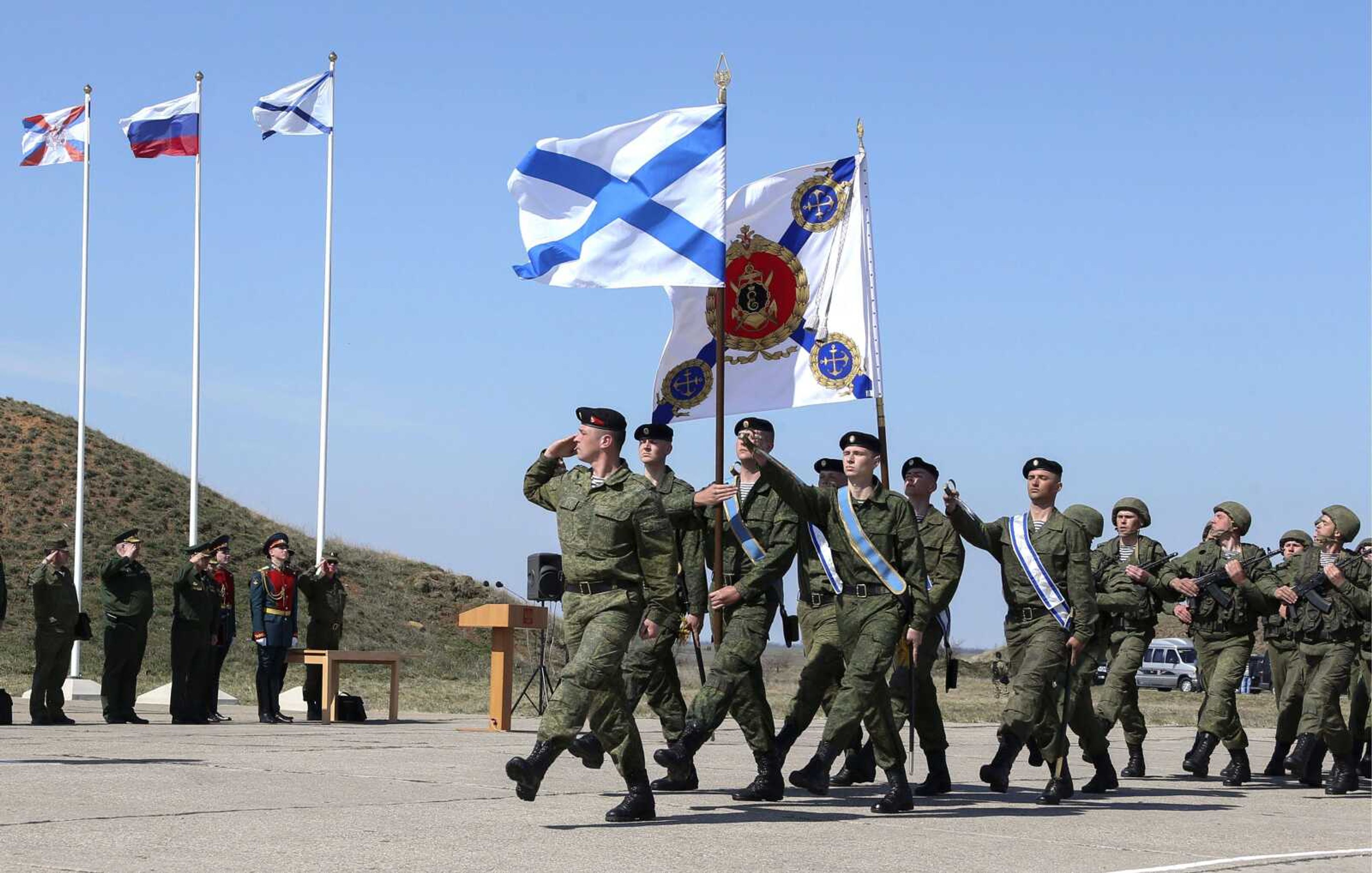 Russian Defense Minister Sergei Shoigu, third from left, looks at Russian marines as they march with the Russian navy Sevastopol&#8217;s flags at a military base Monday in Sevastopol, Crimea. Shoigu&#8217;s visit comes as Ukraine&#8217;s fledgling government on Monday ordered Ukrainian troops to withdraw from Crimea, ending days of wavering as Russian troops consolidate control over the peninsula. (Vadim Savitsky ~ Press Service of Russian Defense Ministry)