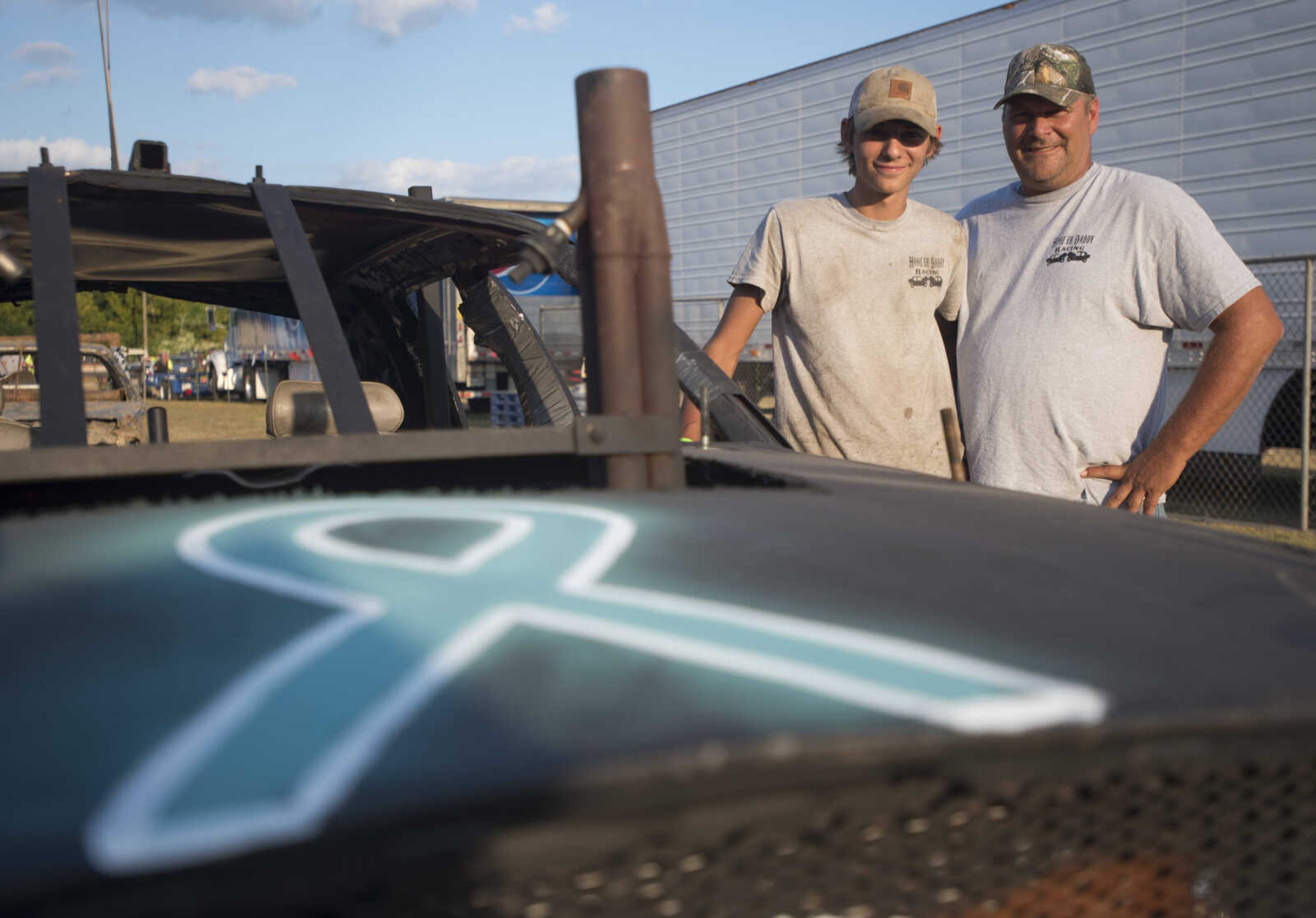 Seth Niederkorn, left, and his father John pose for a photo before the demolition derby September 9, 2017, at the SEMO District Fair in Cape Girardeau.