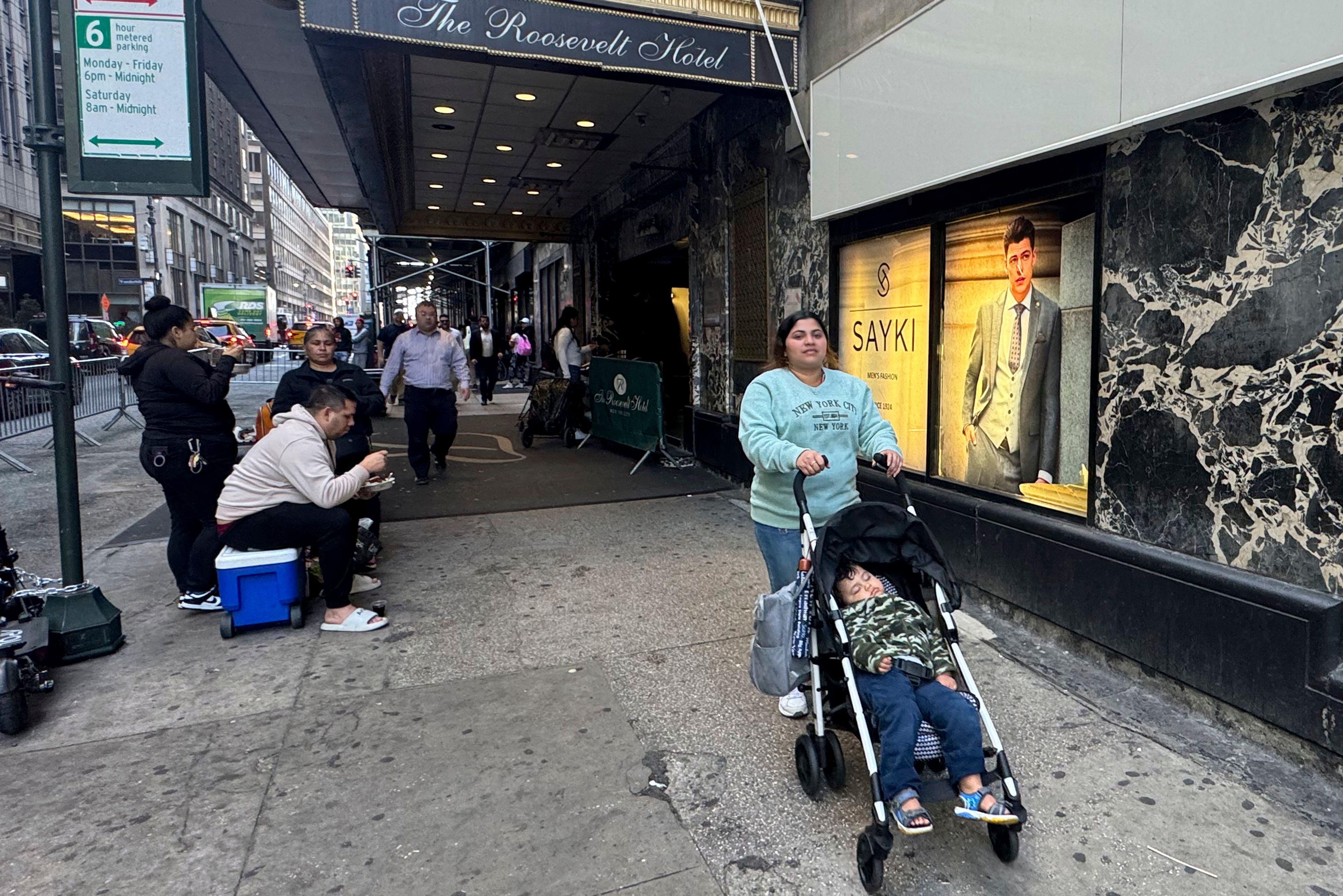 Maribel Hidalgo, 23, an immigrant from Venezuela, pushes a stroller carrying her son, Daniel, 2, outside the Roosevelt Hotel immigration shelter in New York on Wednesday, Nov. 6, 2024. (AP Photo/Cedar Attanasio)