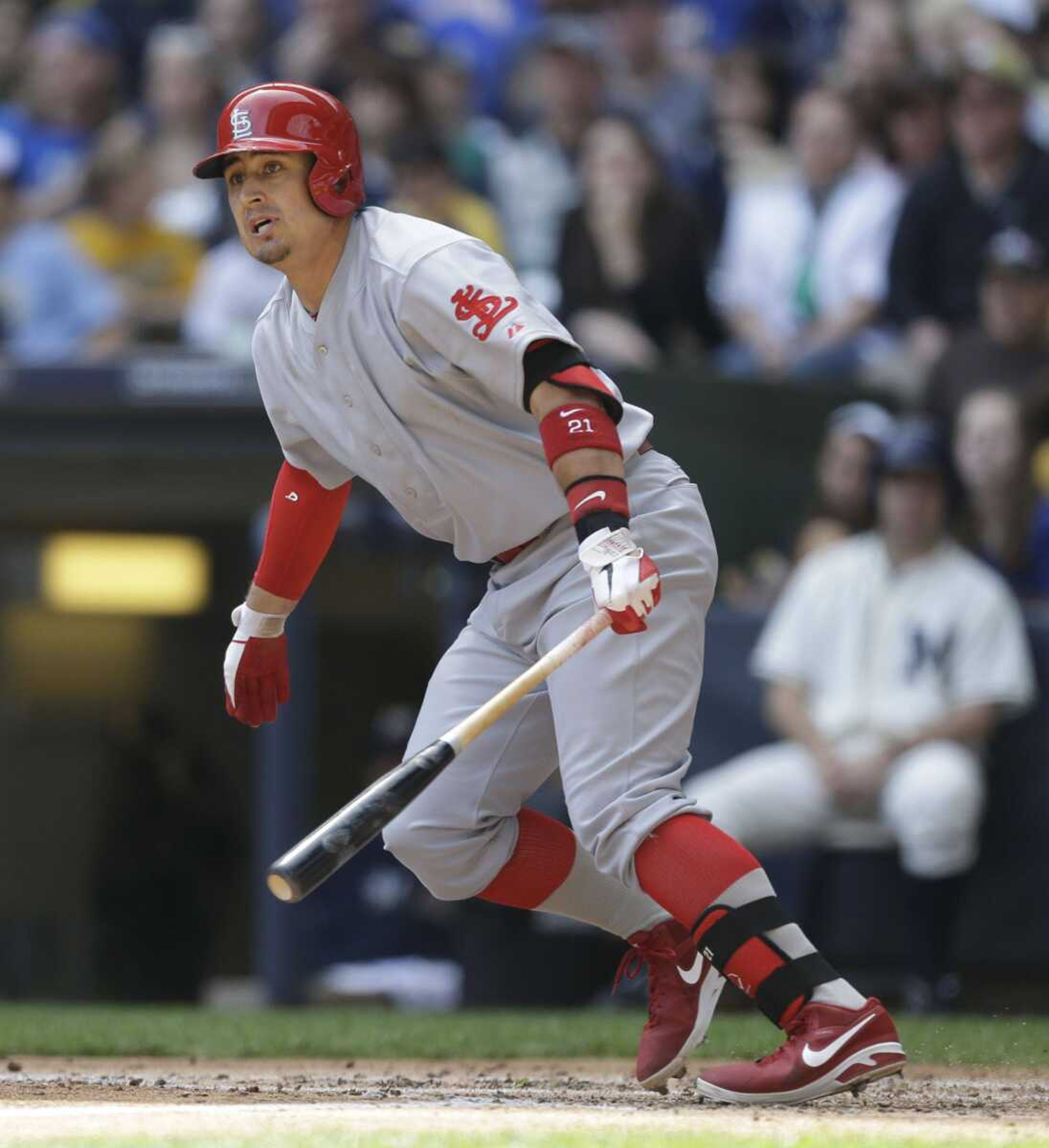 ABOVE: The Cardinals&#8217; Allen Craig watches his three-RBI double against the Brewers during the second inning Sunday in Milwaukee. TOP: Cardinals players line up for the national anthem before the game. Both teams wore 1913 replica uniforms. (Jeffrey Phelps ~ Associated Press)