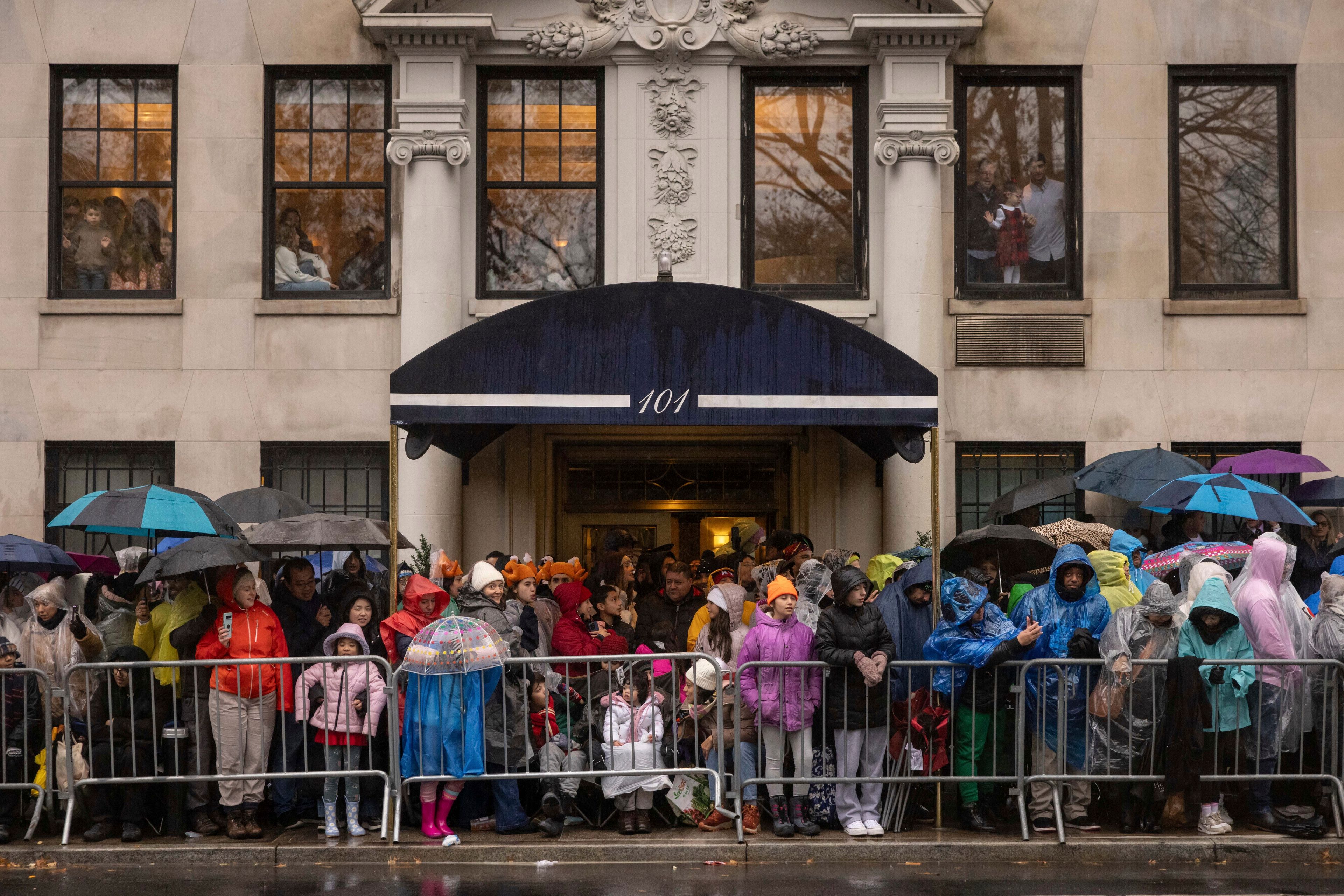 Spectators watch the Macy's Thanksgiving Day Parade, Thursday, Nov. 28, 2024, in New York. (AP Photo/Yuki Iwamura)