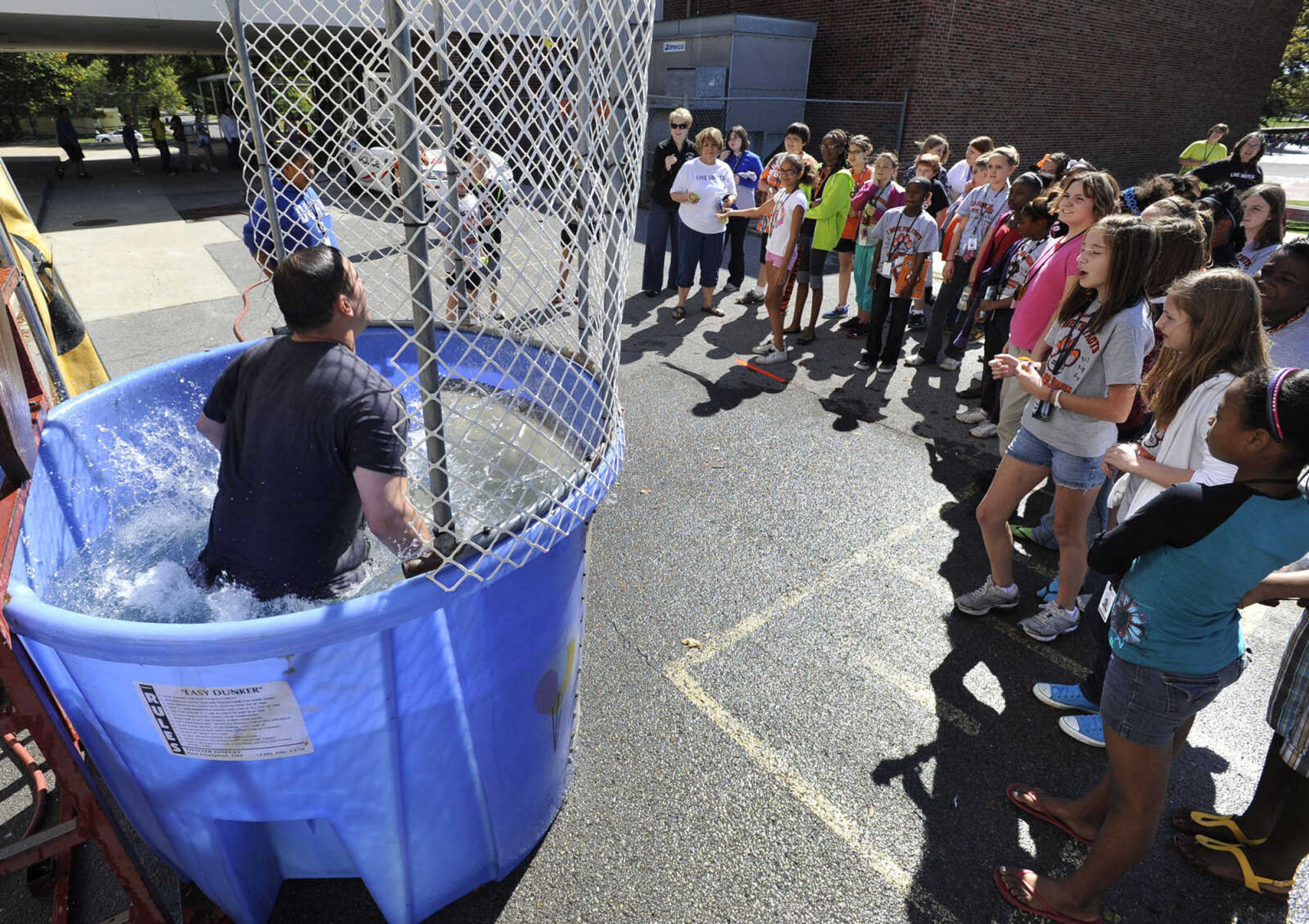 FRED LYNCH ~ flynch@semissourian.com
Assistant principal Rex Crosnoe is dunked with a throw by sixth-grader Jasmine Beard on Friday, Sept. 30, 2011 at Central Middle School.