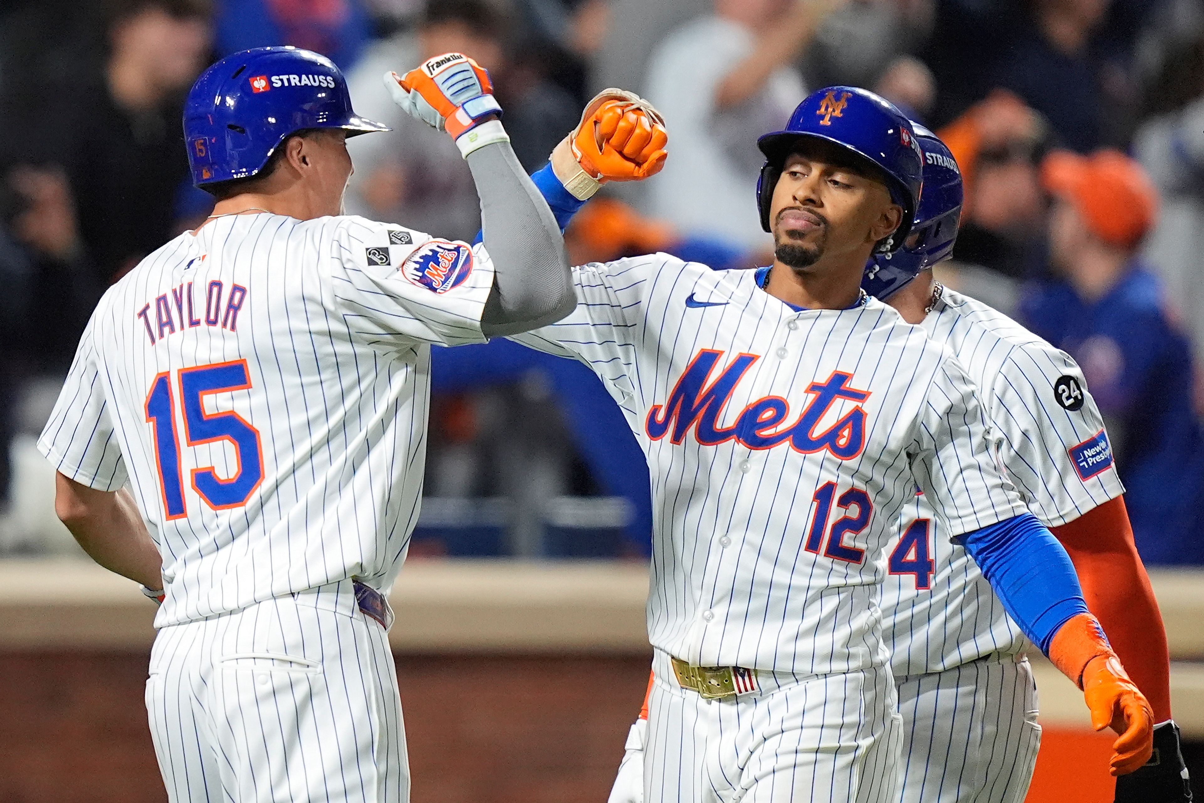 New York Mets' Francisco Lindor (12) is congratulated by Tyrone Taylor (15) after hitting a grand slam home run against the Philadelphia Phillies during the sixth inning of Game 4 of the National League baseball playoff series, Wednesday, Oct. 9, 2024, in New York. (AP Photo/Frank Franklin II)