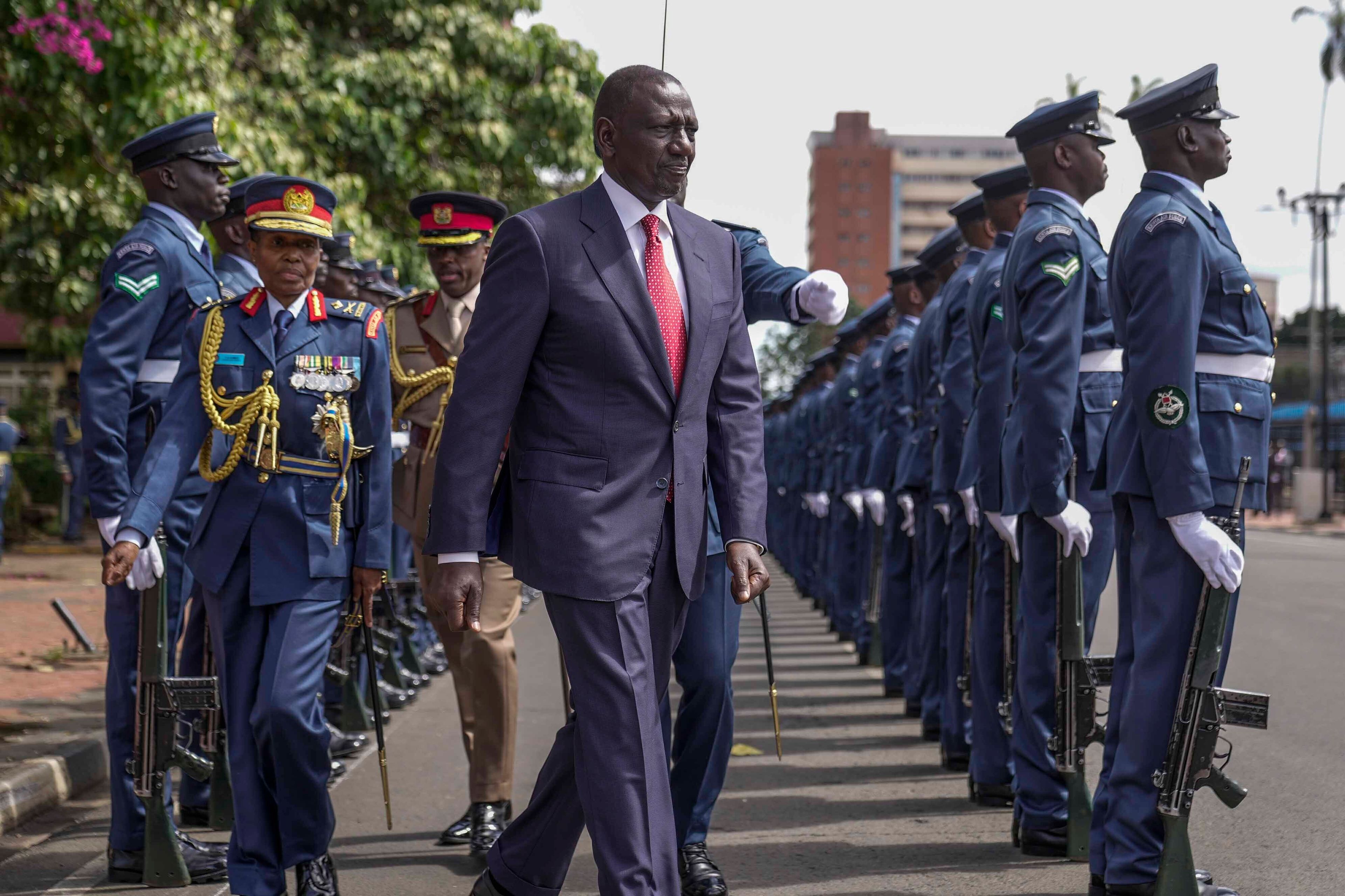 Kenyan President William Ruto, center, reviews the honour guard after arriving to give the State of The Nation address at Parliament buildings in Nairobi, Kenya, Thursday, Nov. 21, 2024. (AP Photo/Brian Inganga)