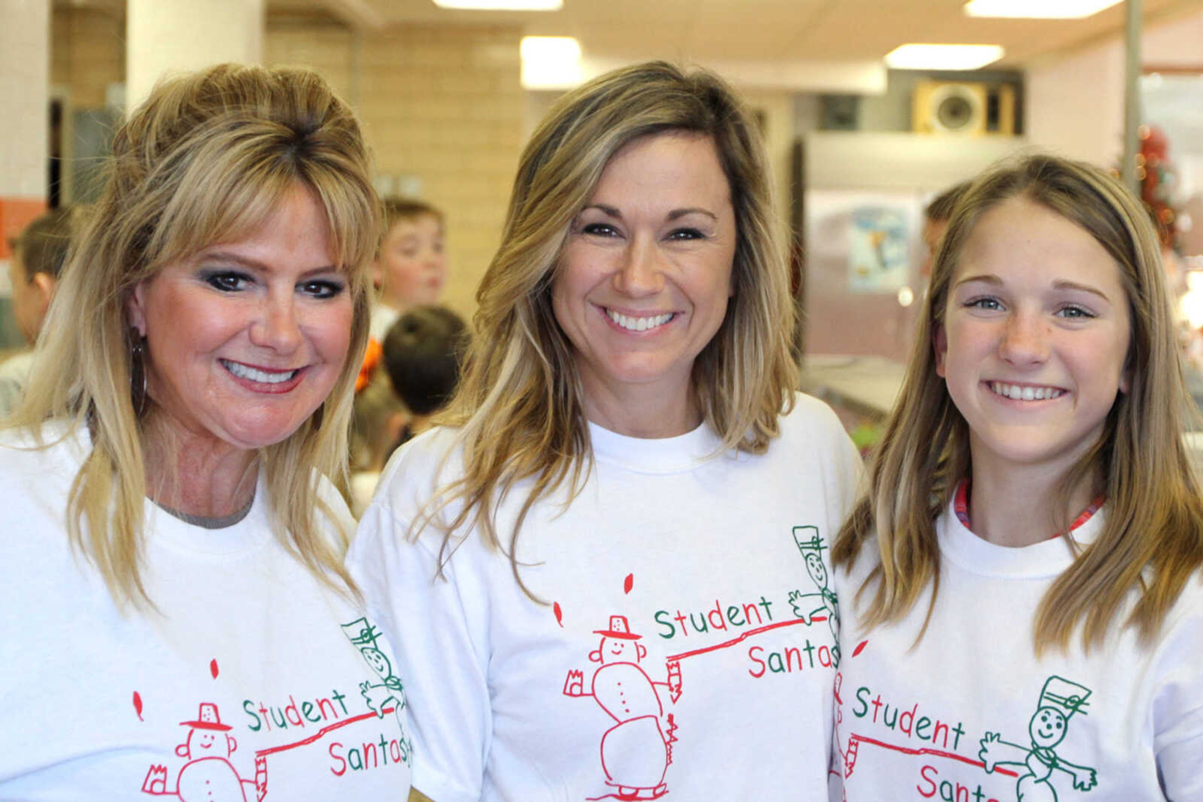 GLENN LANDBERG ~ glandberg@semissourian.com

Rita Dirnberger, left, Tonya and Gracie Friga pose for a photo during the Student Santas Christmas dinner Thursday, Dec. 25, 2014 at Central Junior High School.