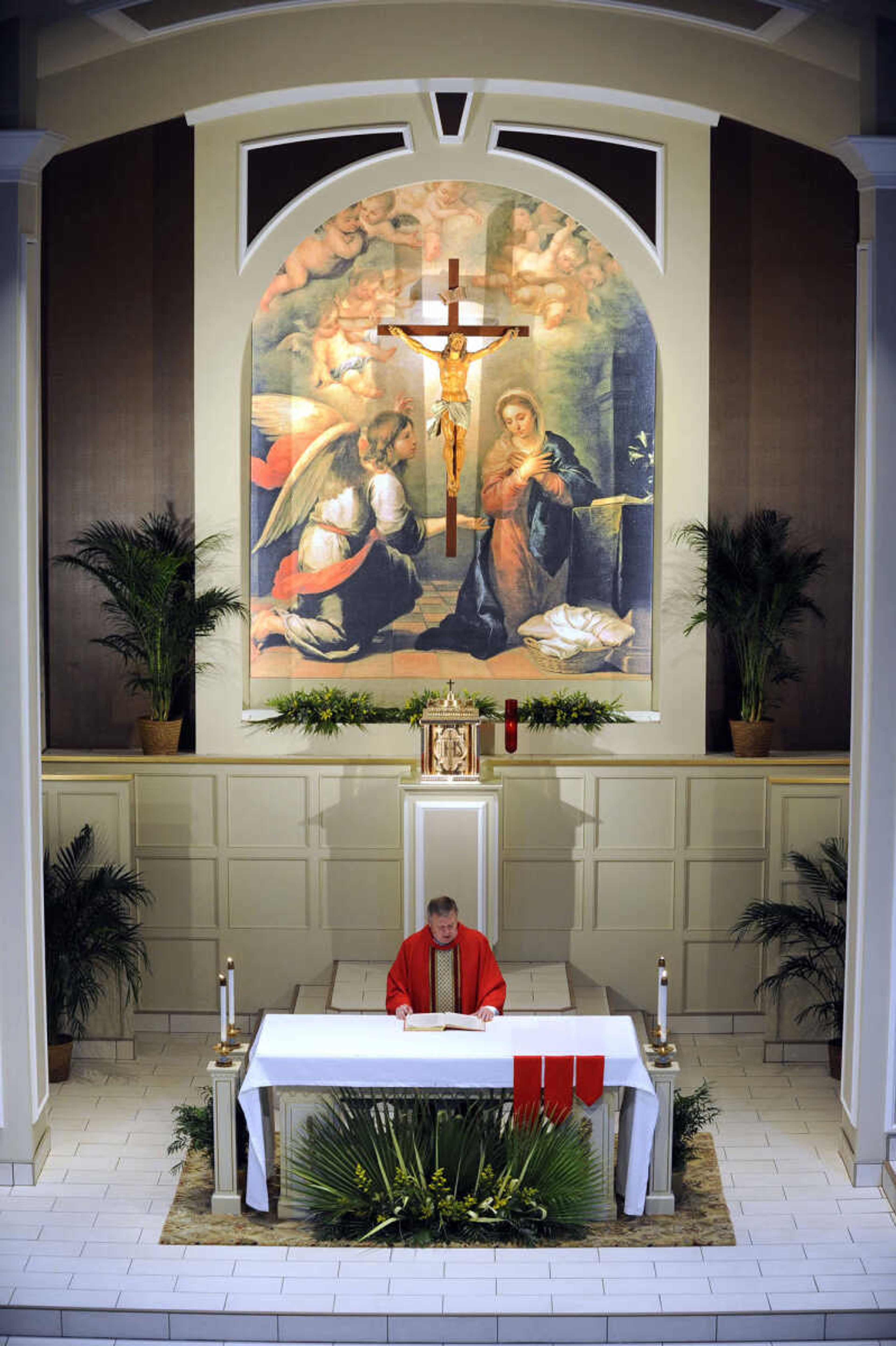 FRED LYNCH ~ flynch@semissourian.com
The Rev. Tom Kiefer, pastor of Cathedral of Saint Mary of the Annunciation, celebrates the first Mass after church renovation in front of the new mural, "Annunciation" by Bartolome Esteban Murillo, on Sunday, April 13, 2014 in Cape Girardeau.