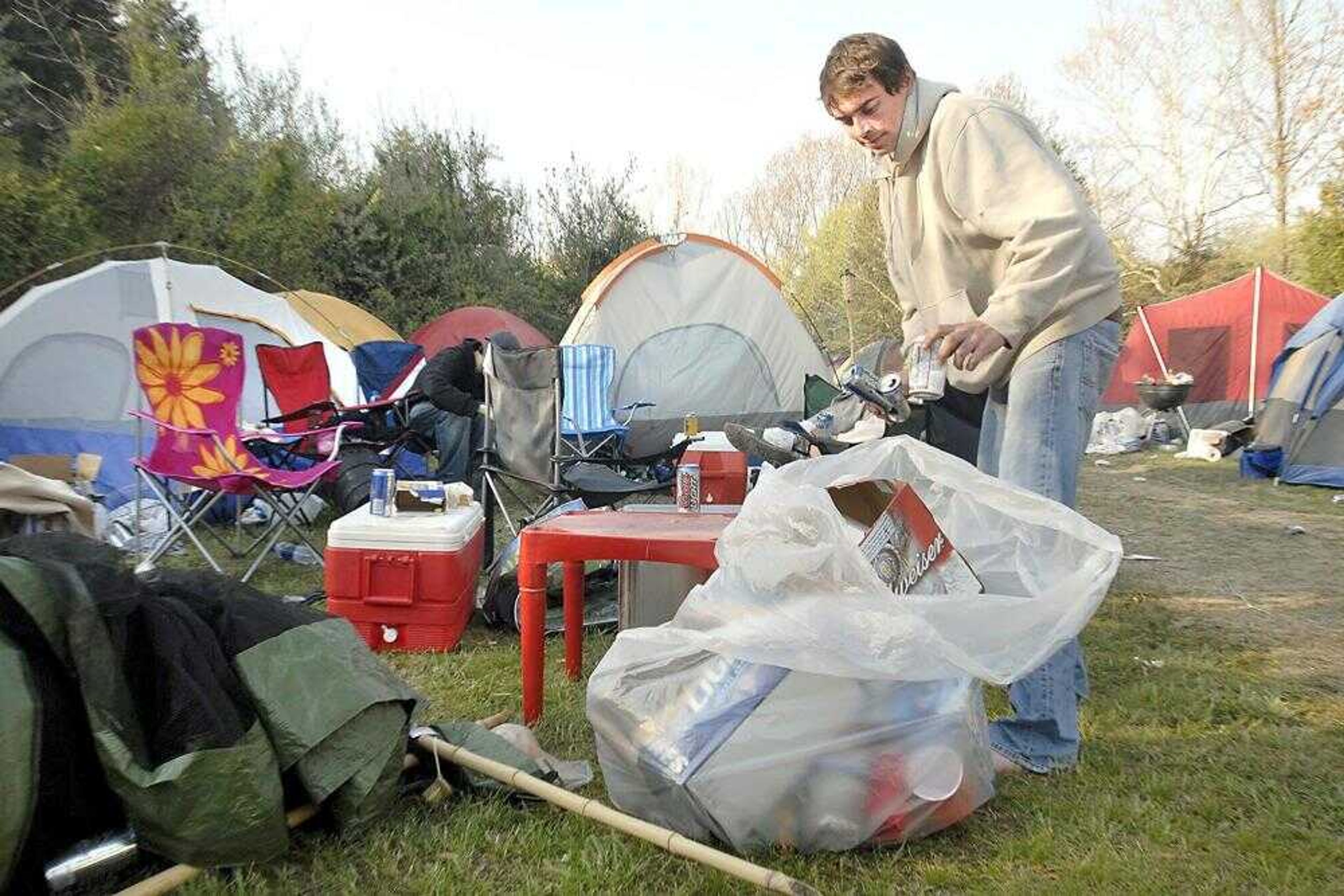 Shaun Stupavsky of Quincy, Ill., observed Earth Day by cleaning up his campsite near Saltpetre Cave, south of Murphysboro, Ill., on Sunday morning after the weekend Cavefest. (Fred Lynch)