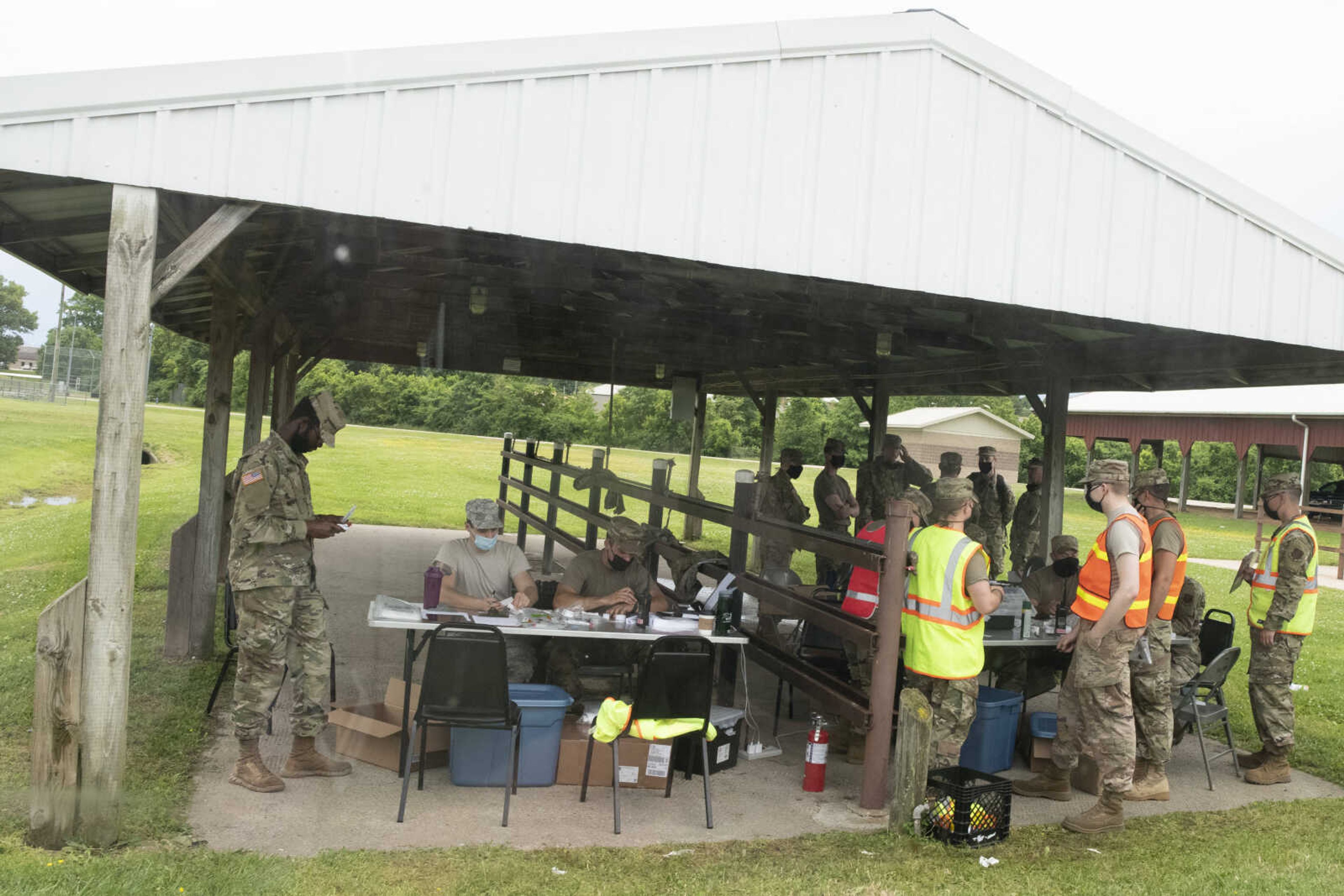 Testing site workers tend to their tasks during free COVID-19 testing Friday, June 5, 2020, at Arena Park in Cape Girardeau. The drive-up testing event was scheduled for 7 a.m. to 7 p.m.