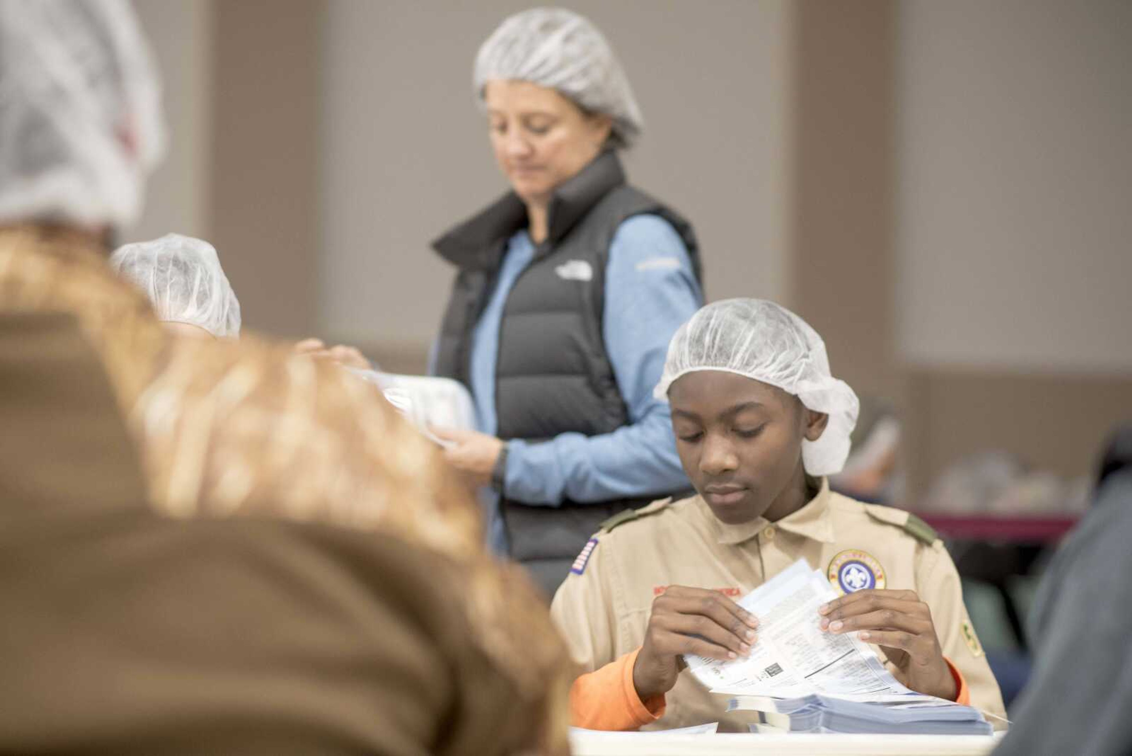 Avery Alexander sorts labels during a Feed My Starving Children meal packing event hosted by La Croix Church Friday, Dec. 6, 2019, at the Osage Centre in Cape Girardeau.