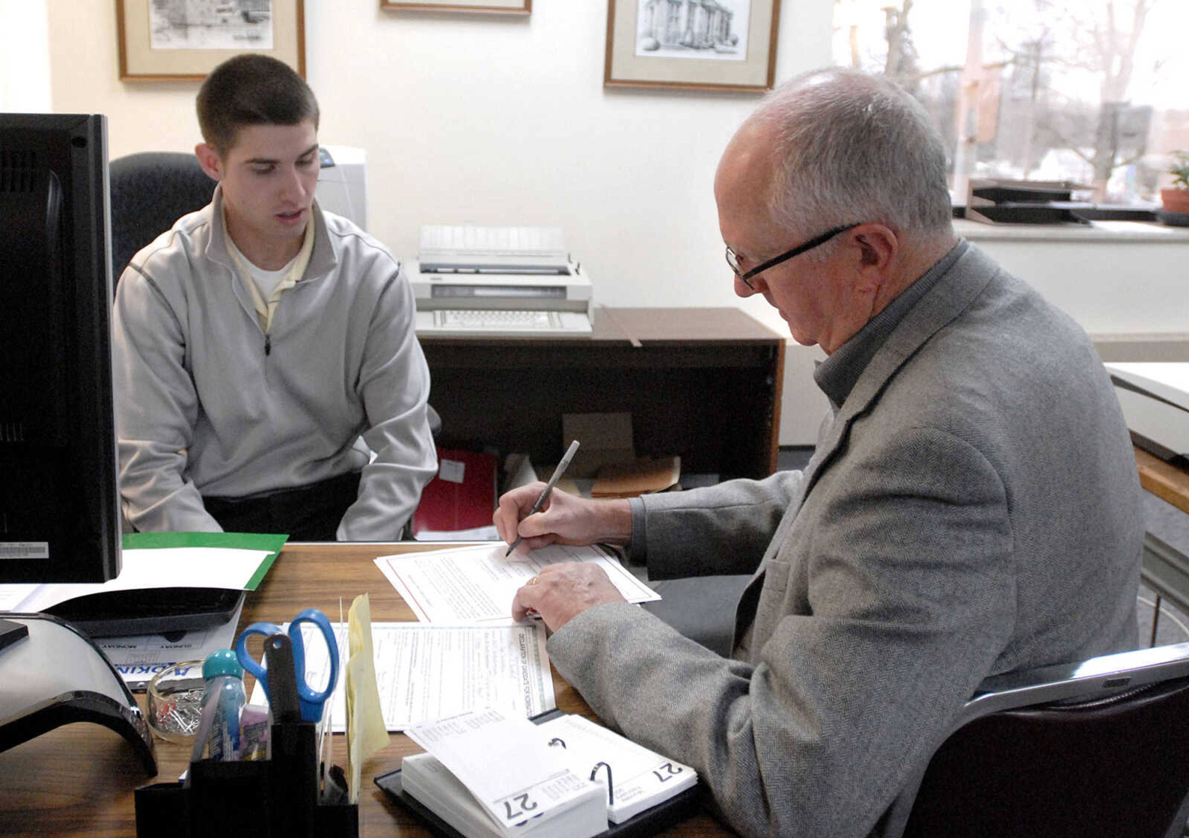 LAURA SIMON ~ lsimon@semissourian.com
Moe Sandfort, a Republican candidate for Cape Girardeau County Commission, fills out campaign paperwork with the assistance of Kyle Basler, an elections assistance specialist.