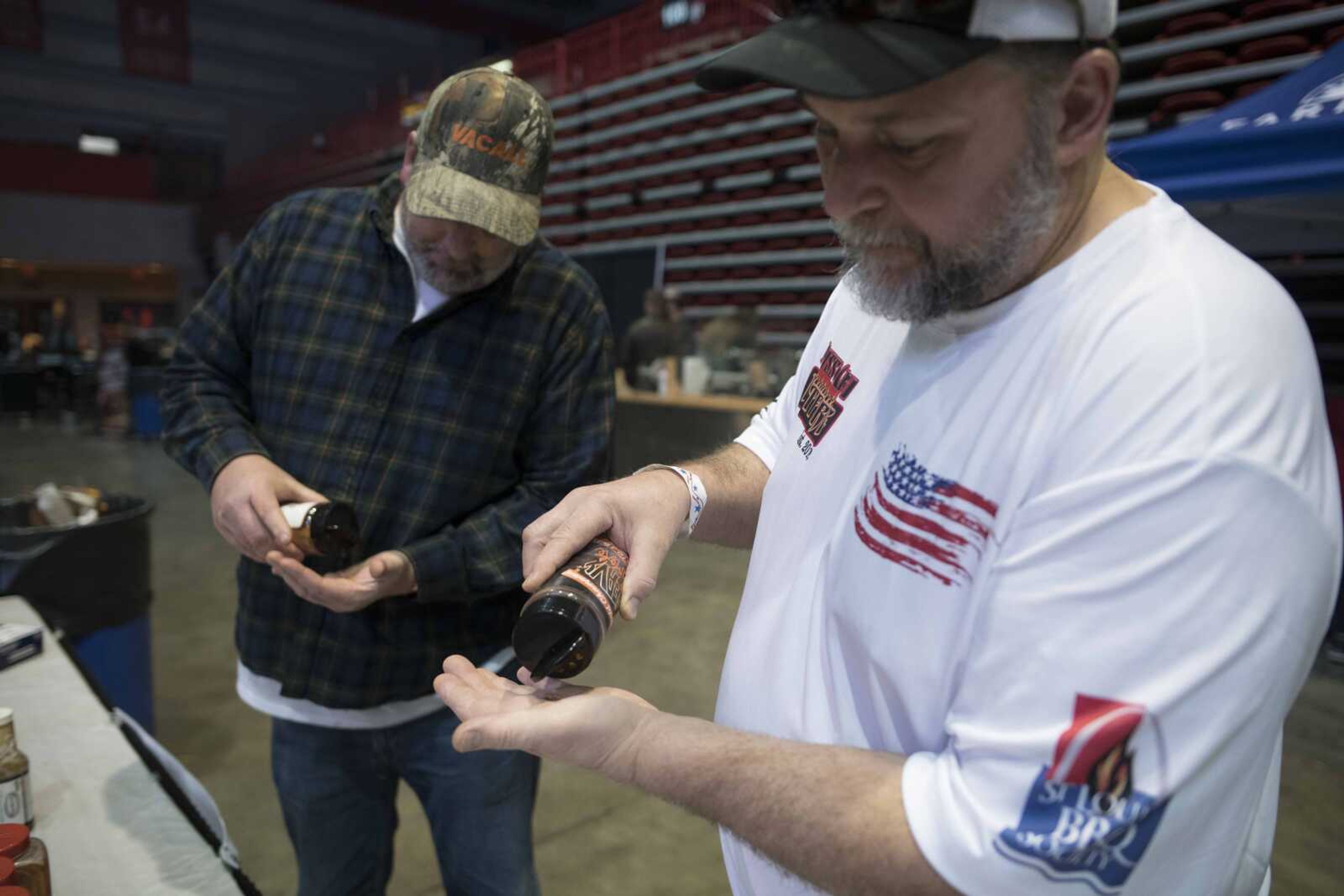 Steve Kovach, right, and Dan Murphy make a taste test of BBQ seasoning during the "When Pigs Fly" indoor BBQ bash Saturday, Jan. 25, 2020, at the Show Me Center in Cape Girardeau.