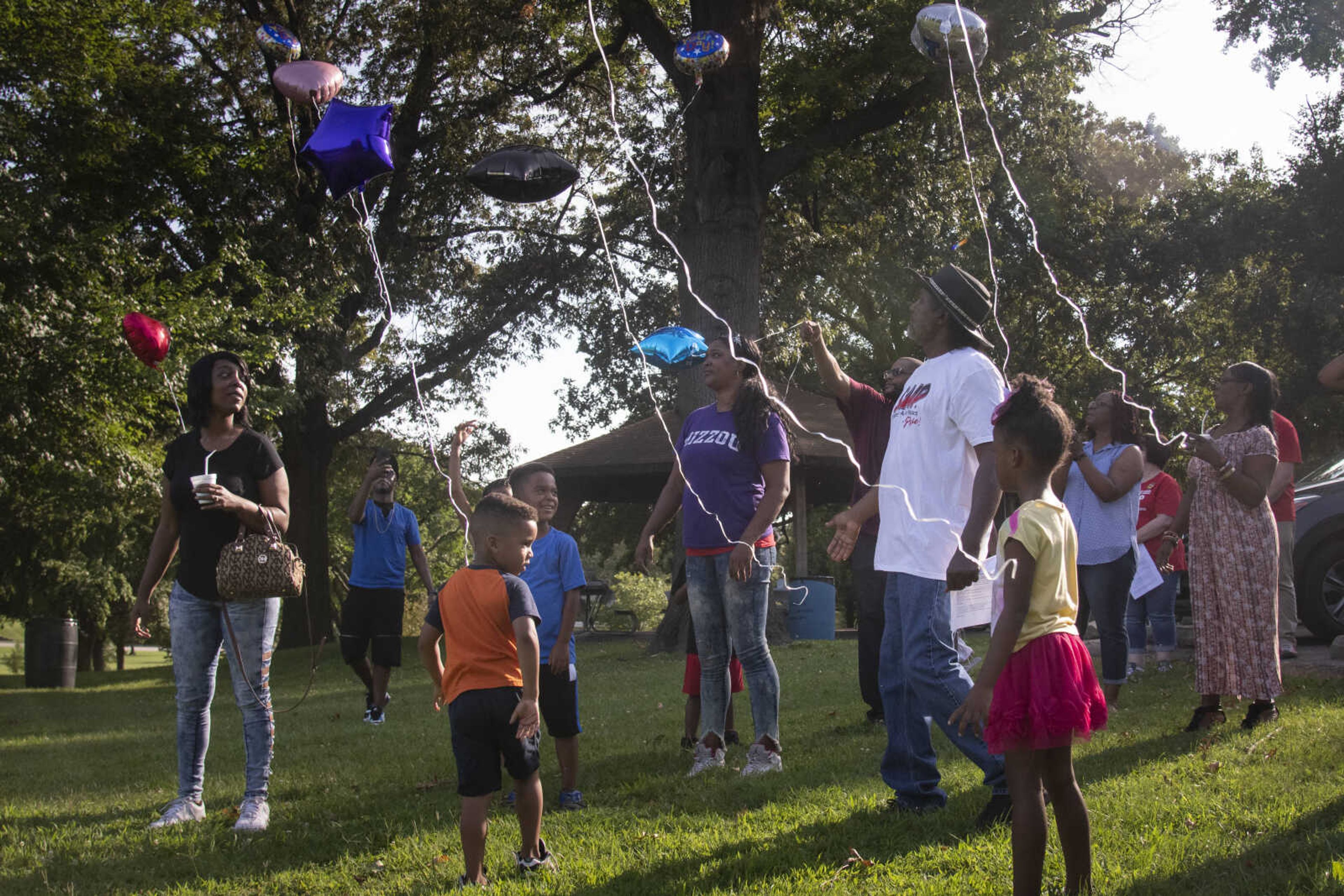 People release balloons into the air during a prayer vigil at the "5th annual Tay Day," in reference to the late Detavian L. Richardson, on Saturday, Aug. 10, 2019, at Capaha Park in Cape Girardeau. The event was organized around the fifth anniversary of the Cape Girardeau shooting deaths of Richardson, 20, and Zatrun R. Twiggs, 28, on Aug. 3, 2014.