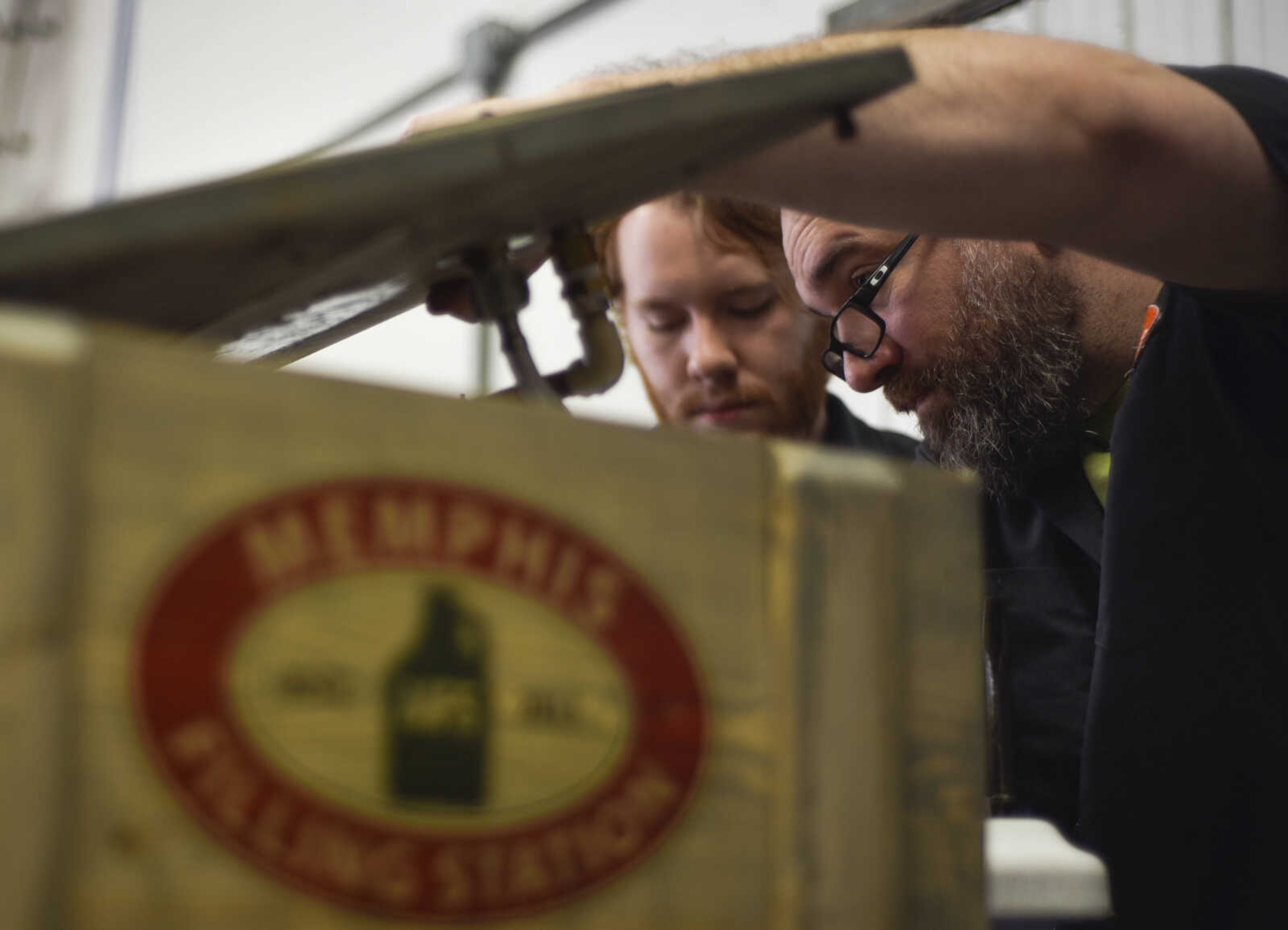 Memphis Filling Station owner&nbsp;Bryan Berretta, right, and Sam Robbins fix a hose line while working their stand at the 9th annual Brew Movement Against Multiple Sclerosis held Saturday, March 24, 2018, in Jackson.