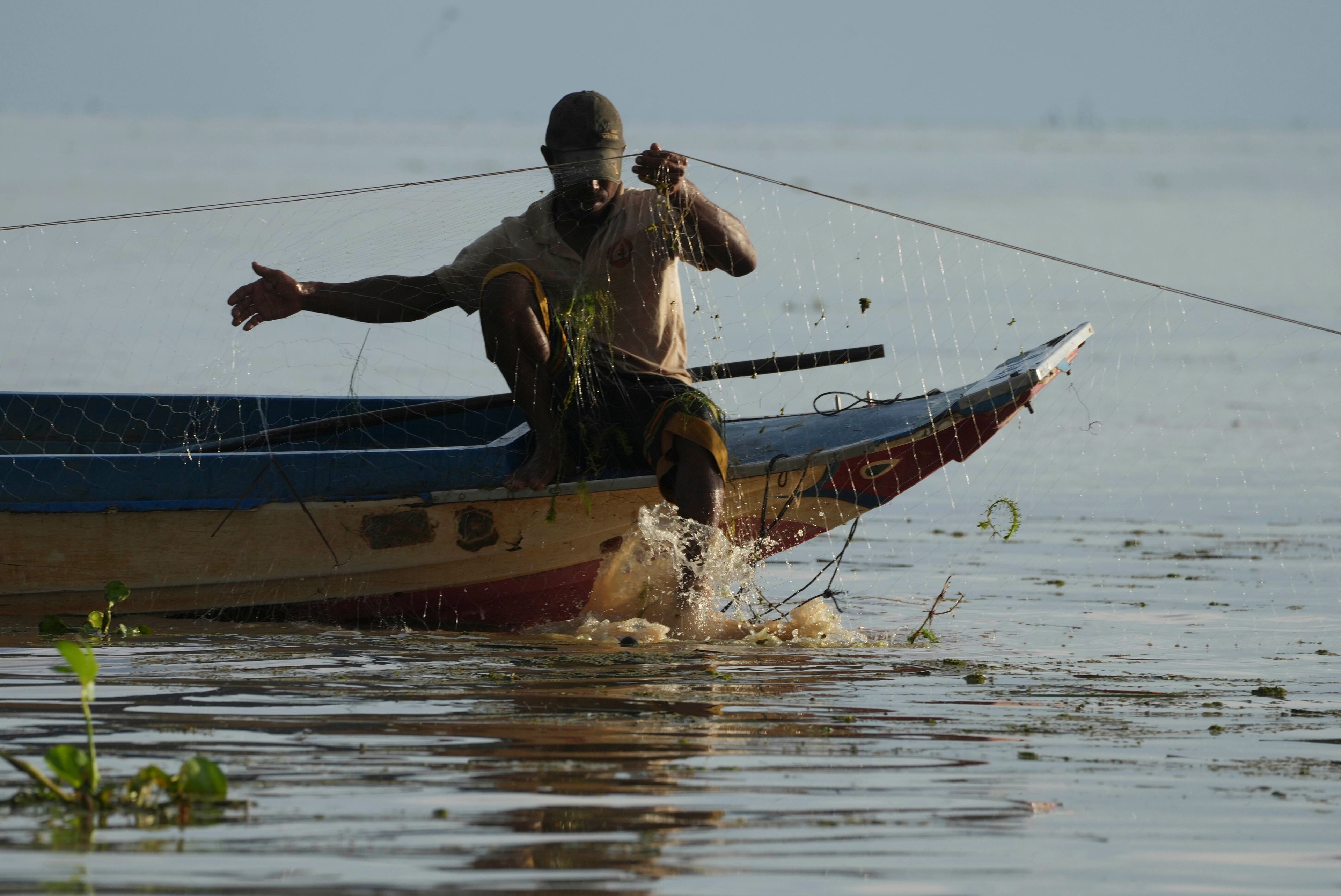 A fisherman fishes in the Tonle Sap in Kampong Chhnang province, Cambodia, Thursday, Aug. 1, 2024, (AP Photo/Heng Sinith)