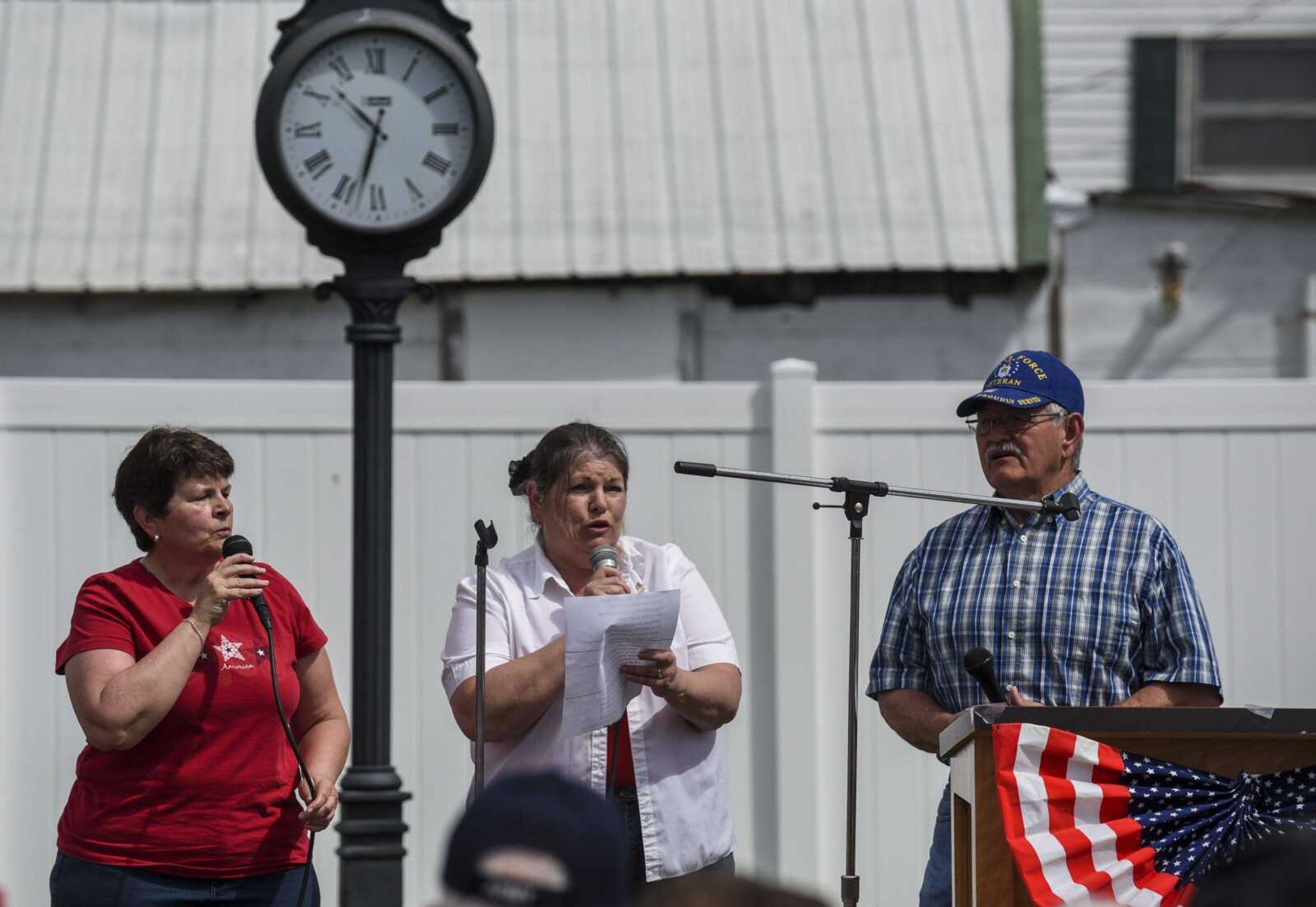 From left, Scott City graduates and community members Patty Rhymer, Penny Rhymer Davidson and Roger Rhymer sing patriotic songs at the Honoring Our Military event Saturday at the Scott City Historical Museum in Scott City.