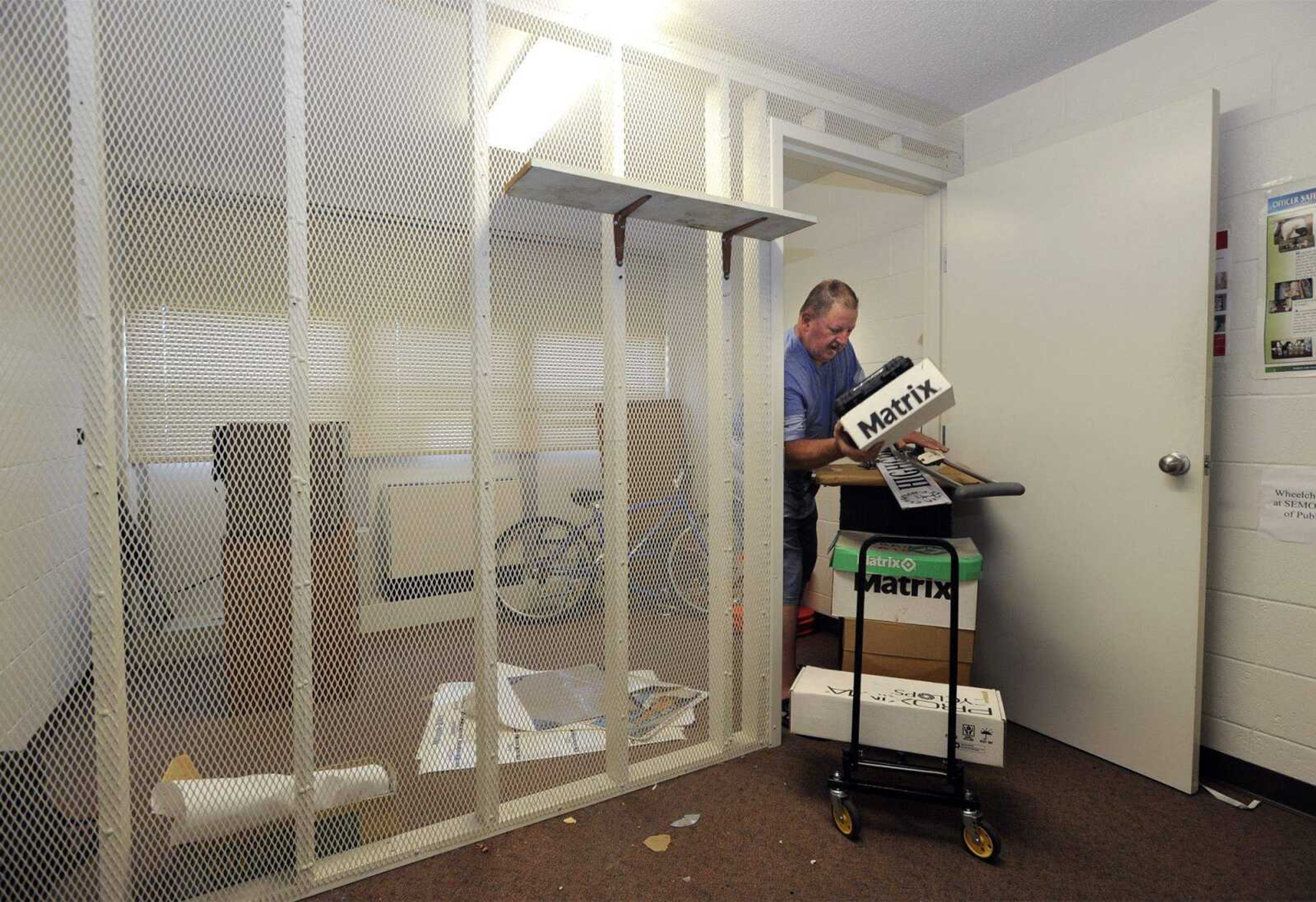 Al Moore clears out items from the evidence and found property room in Dearmont D building, which formerly housed the university's Department of Public Safety, on Wednesday. The room will be converted back to student housing. (Fred Lynch)