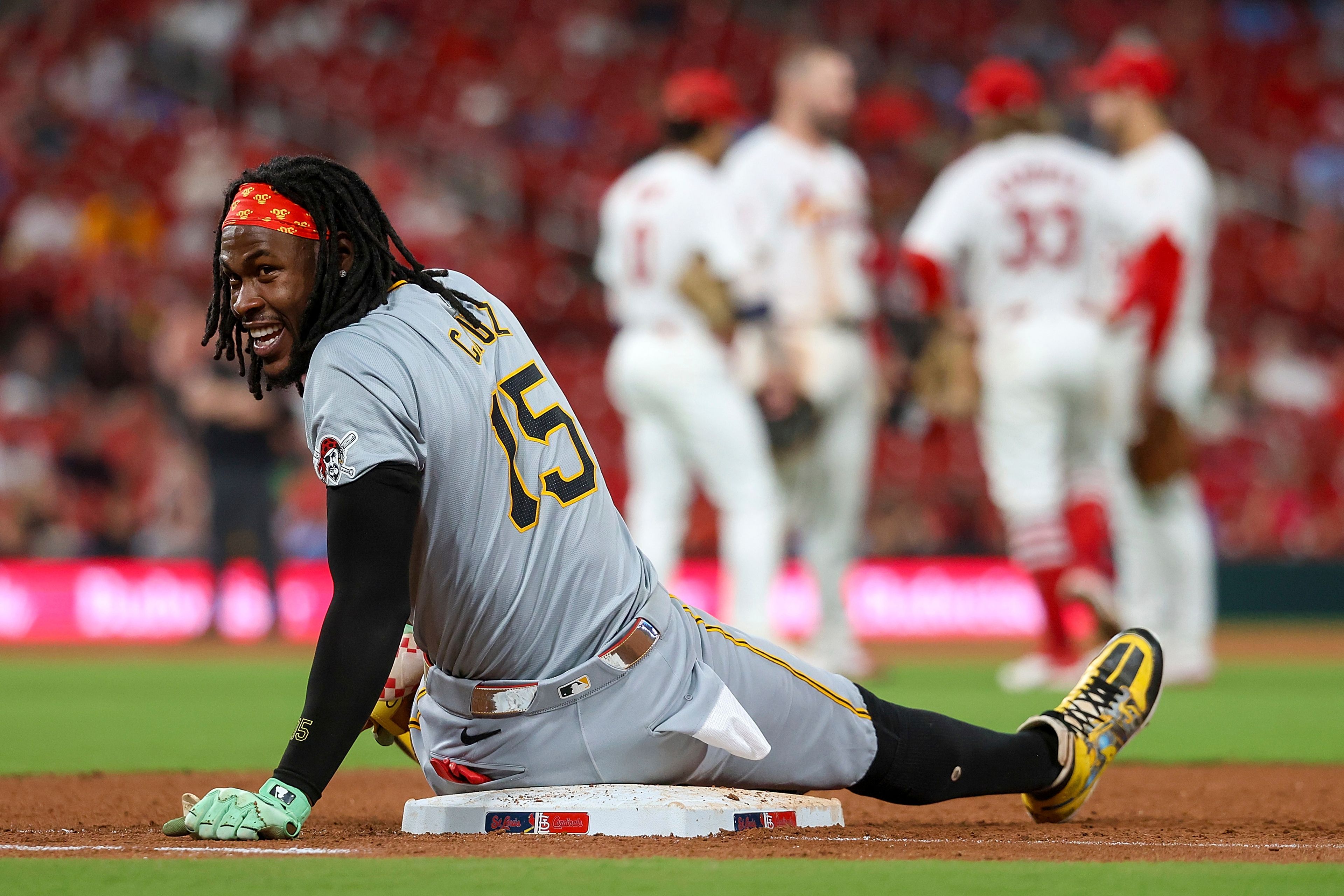 Pittsburgh Pirates' Oneil Cruz sits on first base as he waits for a St. Louis Cardinals pitching change to be completed during the eighth inning of a baseball game Thursday, Sept. 19, 2024, in St. Louis. (AP Photo/Scott Kane)