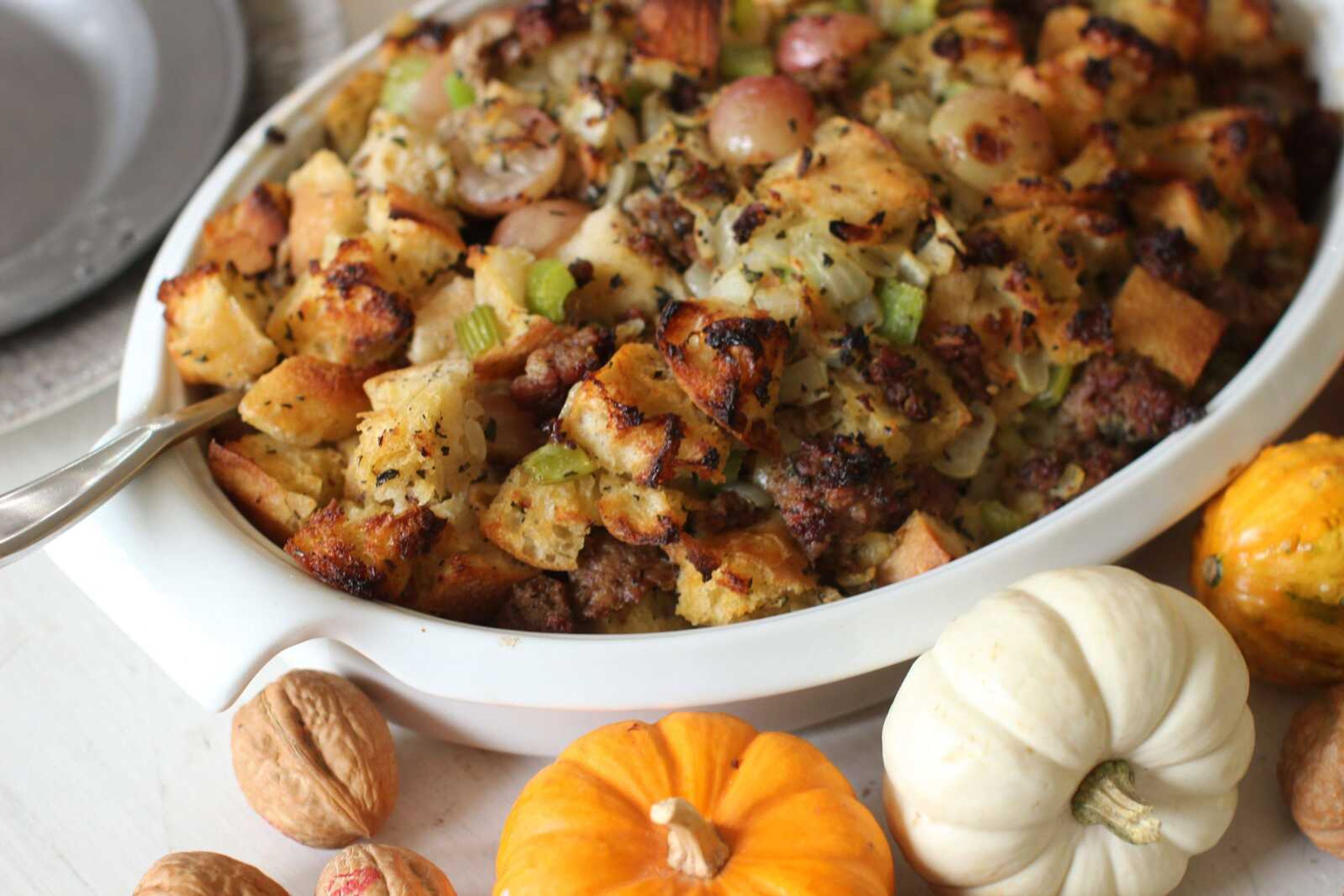 This photo shows sausage and grape Thanksgiving stuffing. Making one giant batch of stuffing allows for some of it to be used to stuff the turkey, while the rest can be put into a well-buttered baking dish. (AP Photo/Matthew Mead)