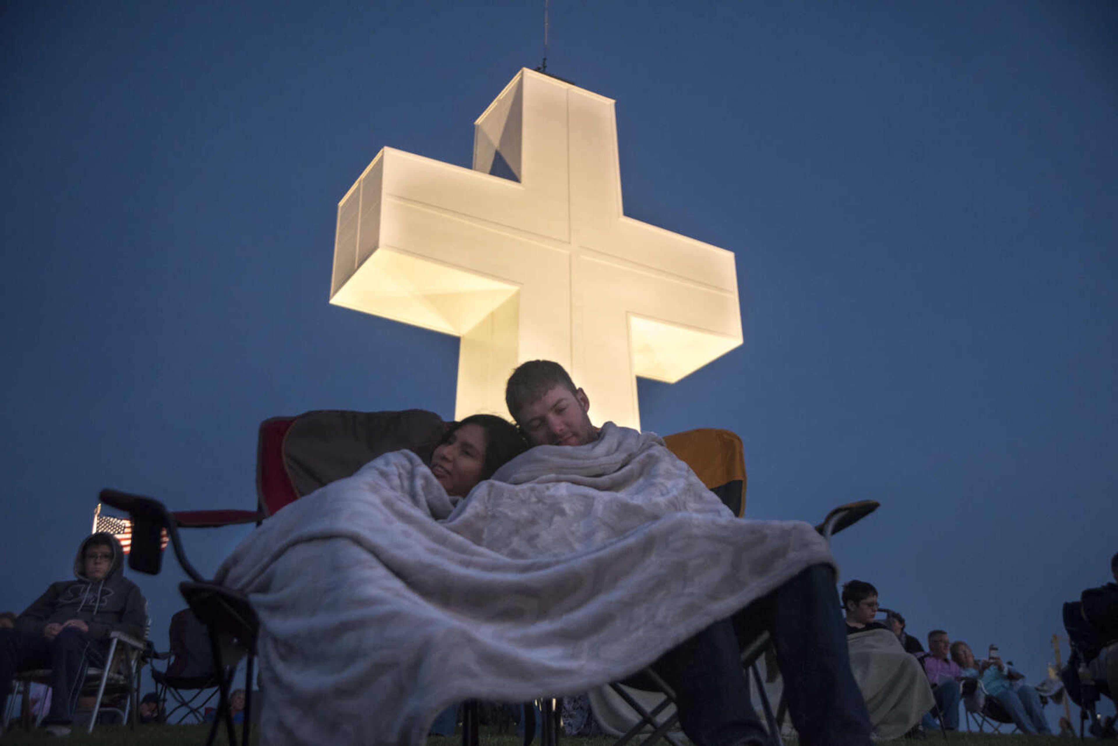 Johnathan Oberholz and Kelsey Kattenbreaker wrap up with a blanket during the 81st annual Easter Sunrise Service at the Bald Knob Cross of Peace Sunday, April 16, 2017 in Alto Pass, Illinois.