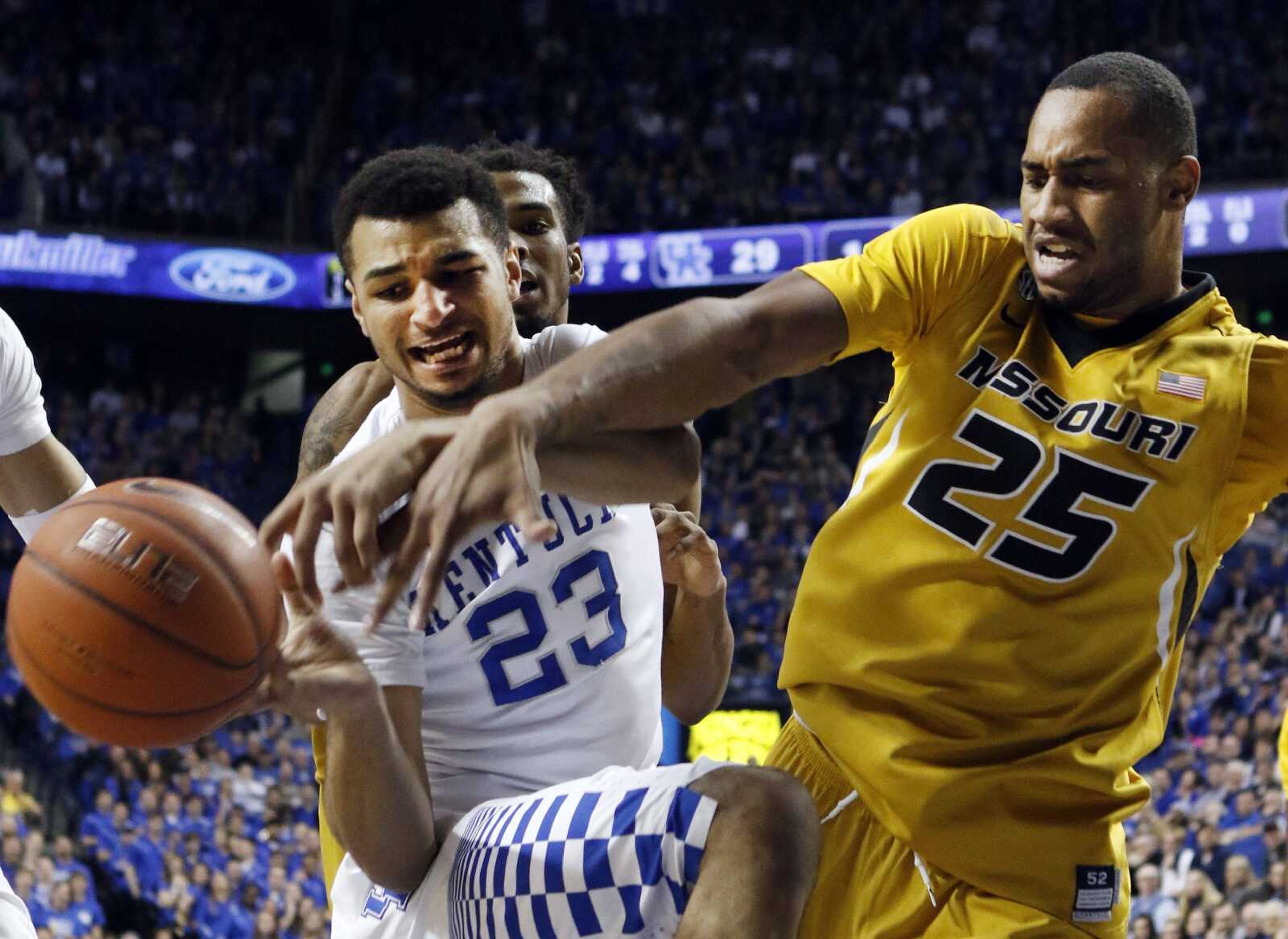 Kentucky's Jamal Murray, left, and Missouri's Russell Woods fight for a loose ball during the first half of Wednesday's game in Lexington, Kentucky.