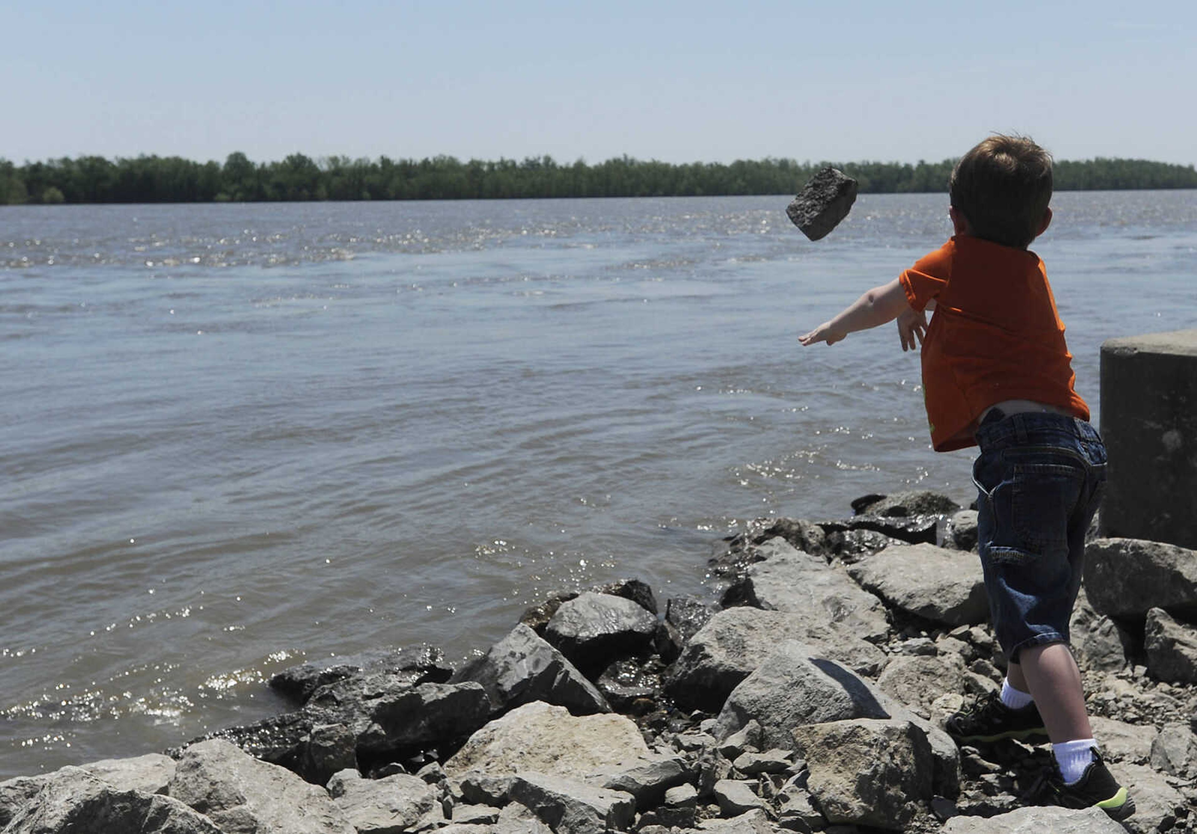 Colin Vickory, 5, throws a rock into the Mississippi River at Riverfront Park Wednesday, May 15, in Cape Girardeau. The Broadway floodgate has been opened but the floodgate at Themis Street remains closed.