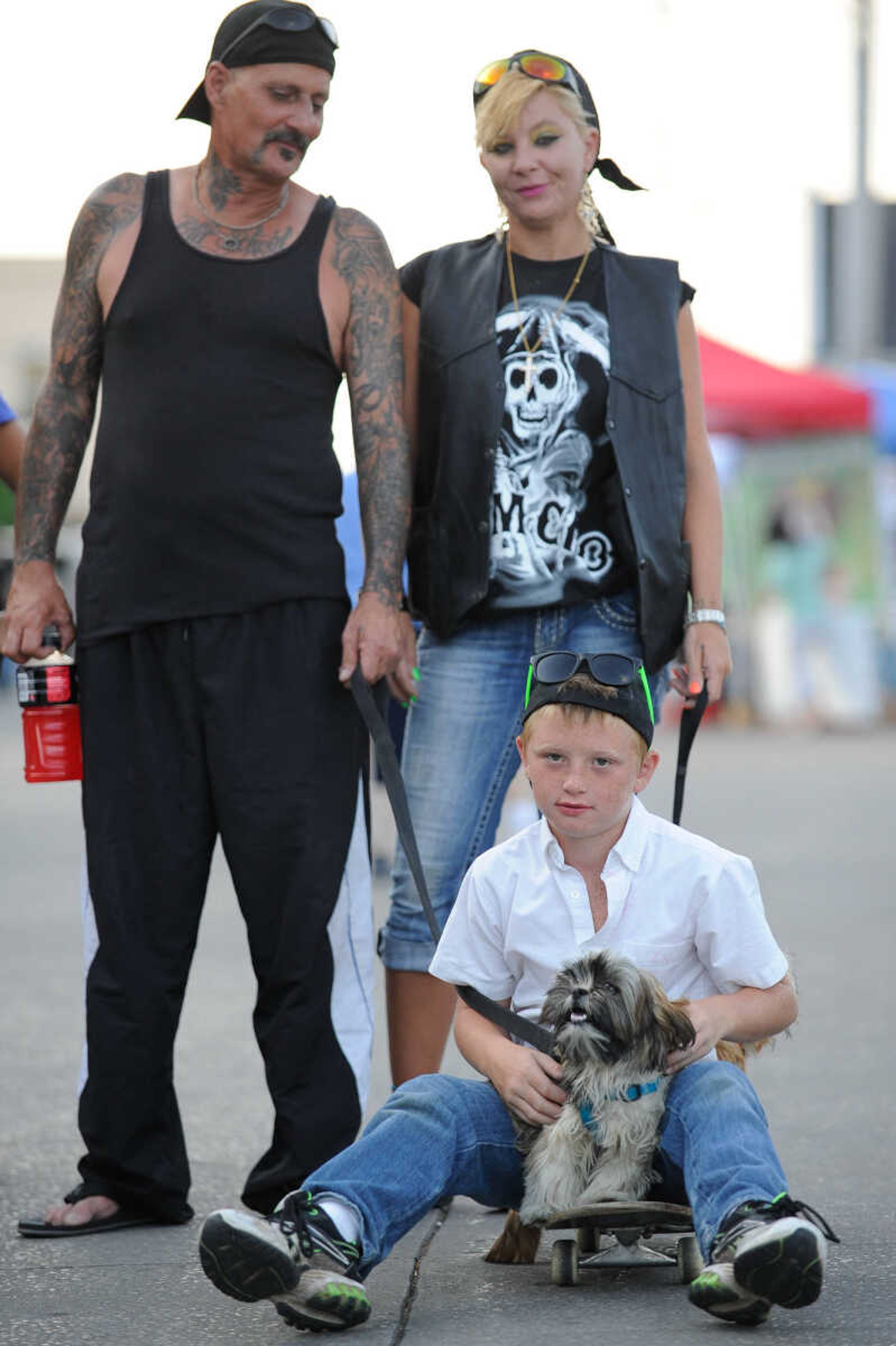 GLENN LANDBERG ~ glandberg@semissourian.com

Joseph Reynolds rest on a skateboard with his parents Beth and Terry Mullins during the 4th Annual Bikers on the Square Friday, June 17, 2016 in Perryville, Missouri.