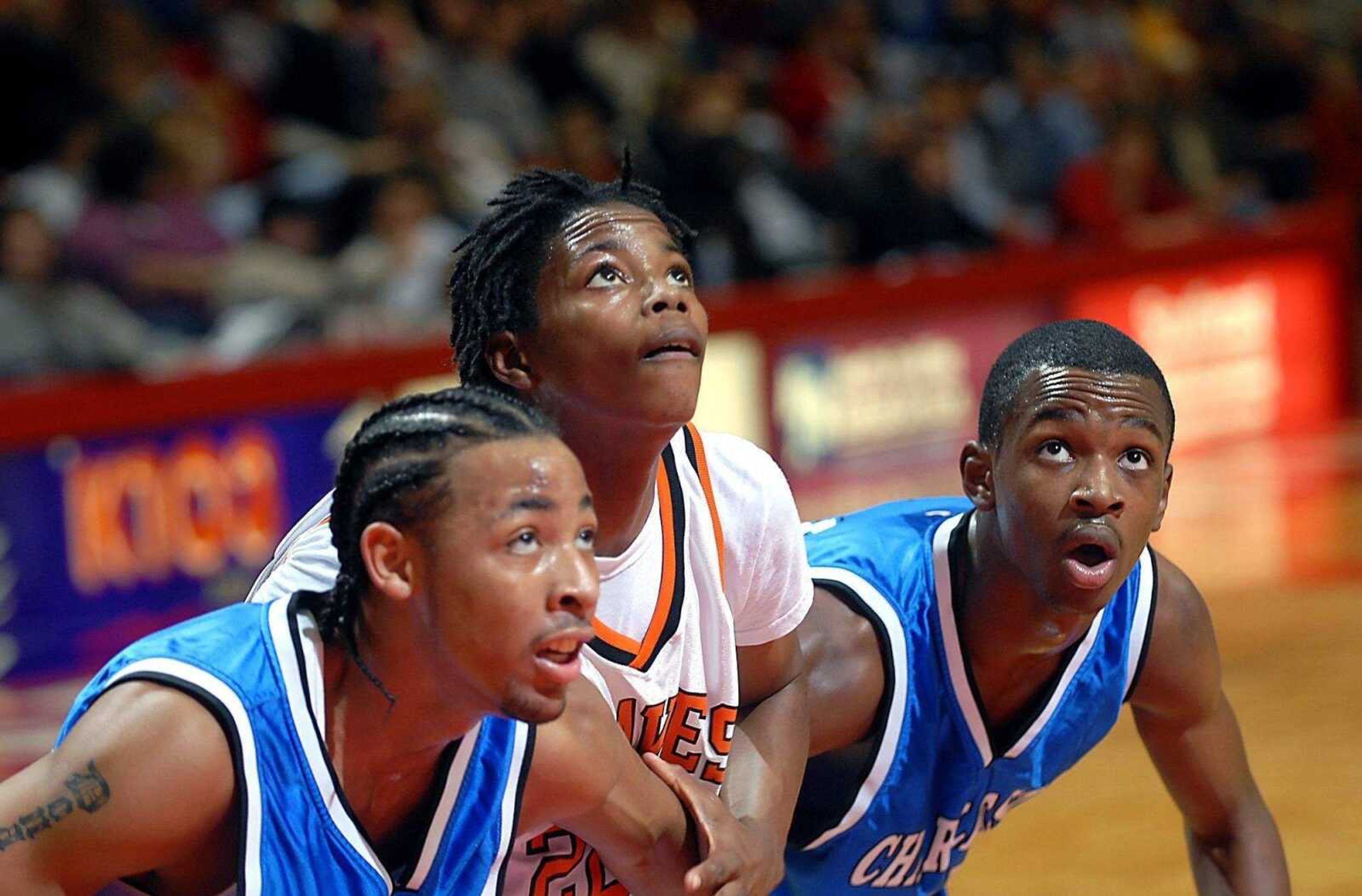 KIT DOYLE ~ kdoyle@semissourian.comDonald Dixon, left, Desmin Williams, and Demarques McKeller watch a free throw head to the rim Monday evening, December 29, 2008, in the Southeast Missourian Christmas Tournament at the Show Me Center.