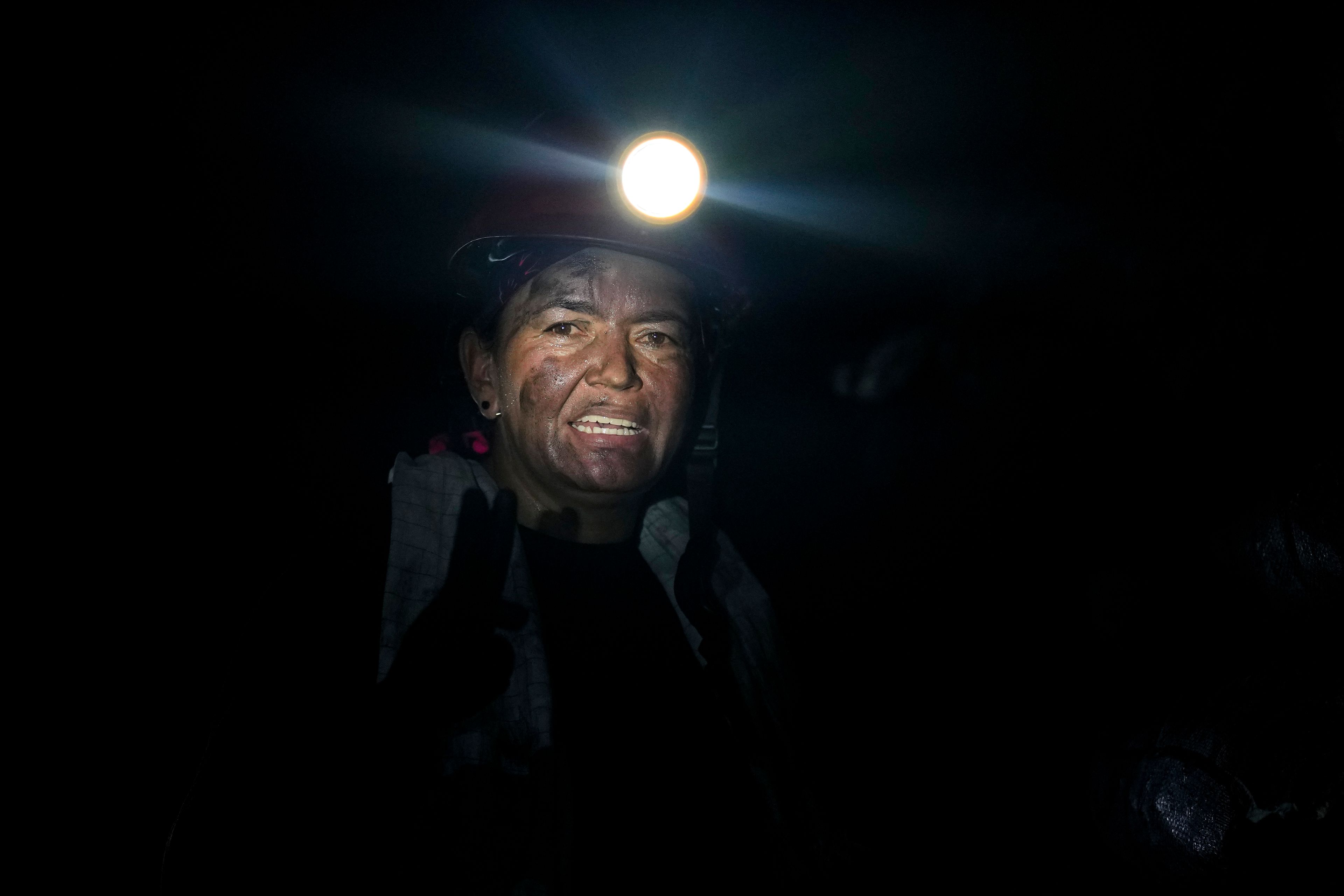 Emerald miner Janeth Paez stands inside the tunnel of an informal mine near the town of Coscuez, Colombia, on Feb. 28, 2024. (AP Photo/Fernando Vergara)