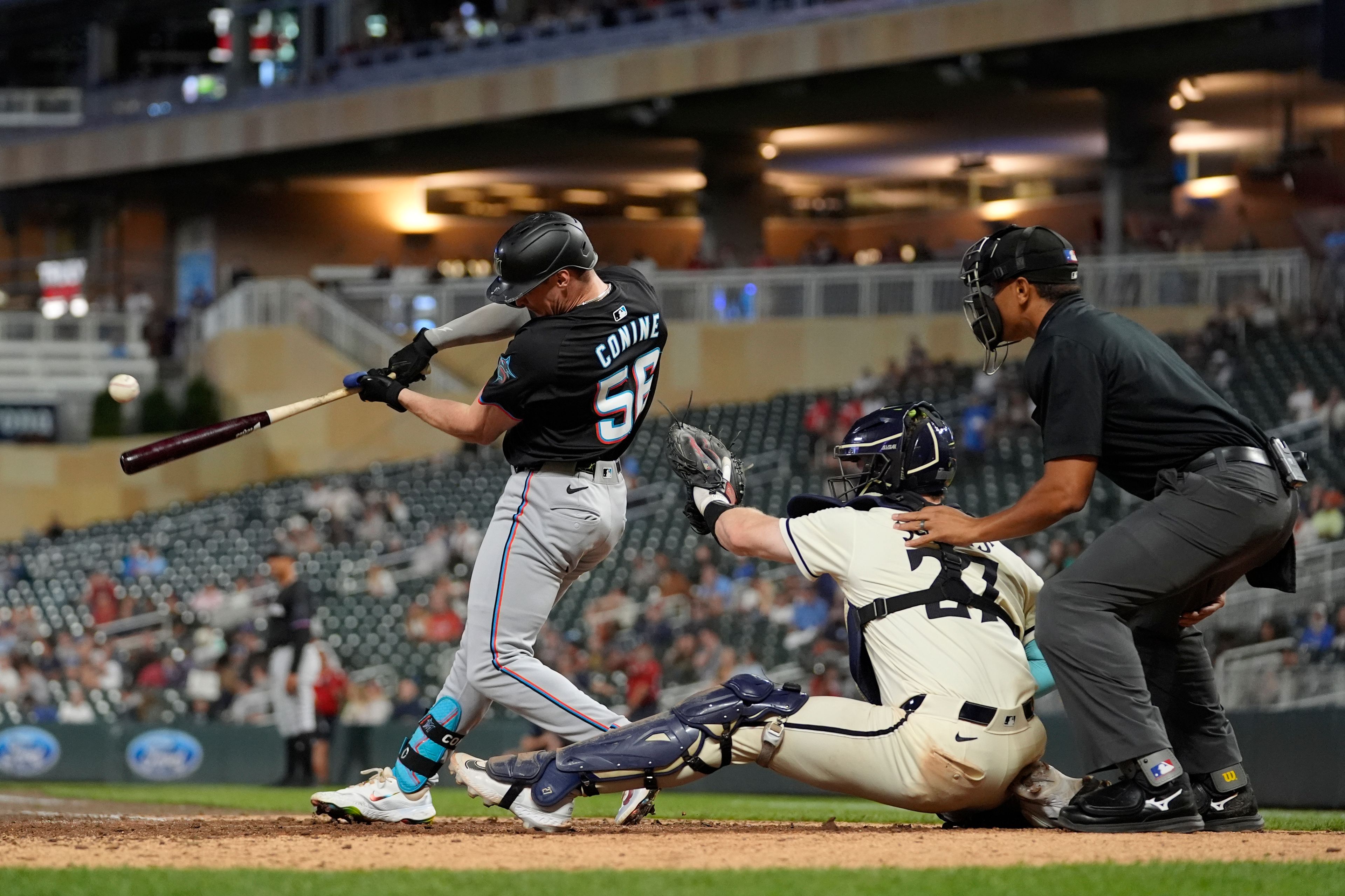 Miami Marlins' Griffin Conine (56) hits a two-run single during the 13th inning of a baseball game against the Minnesota Twins, Thursday, Sept. 26, 2024, in Minneapolis. (AP Photo/Abbie Parr)