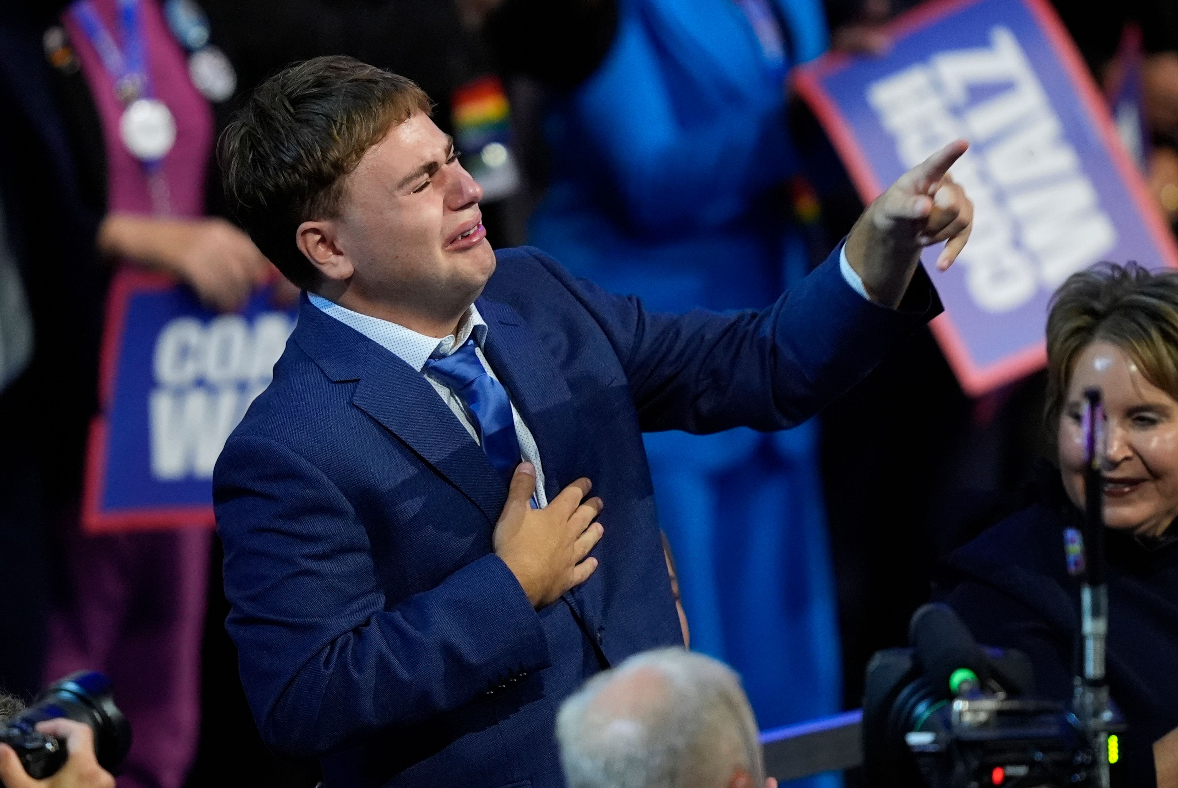 Gus Walz cries as his father Democratic vice presidential nominee Minnesota Gov. Tim Walz speaks during the Democratic National Convention Wednesday, Aug. 21, 2024, in Chicago. (AP Photo/Charles Rex Arbogast)