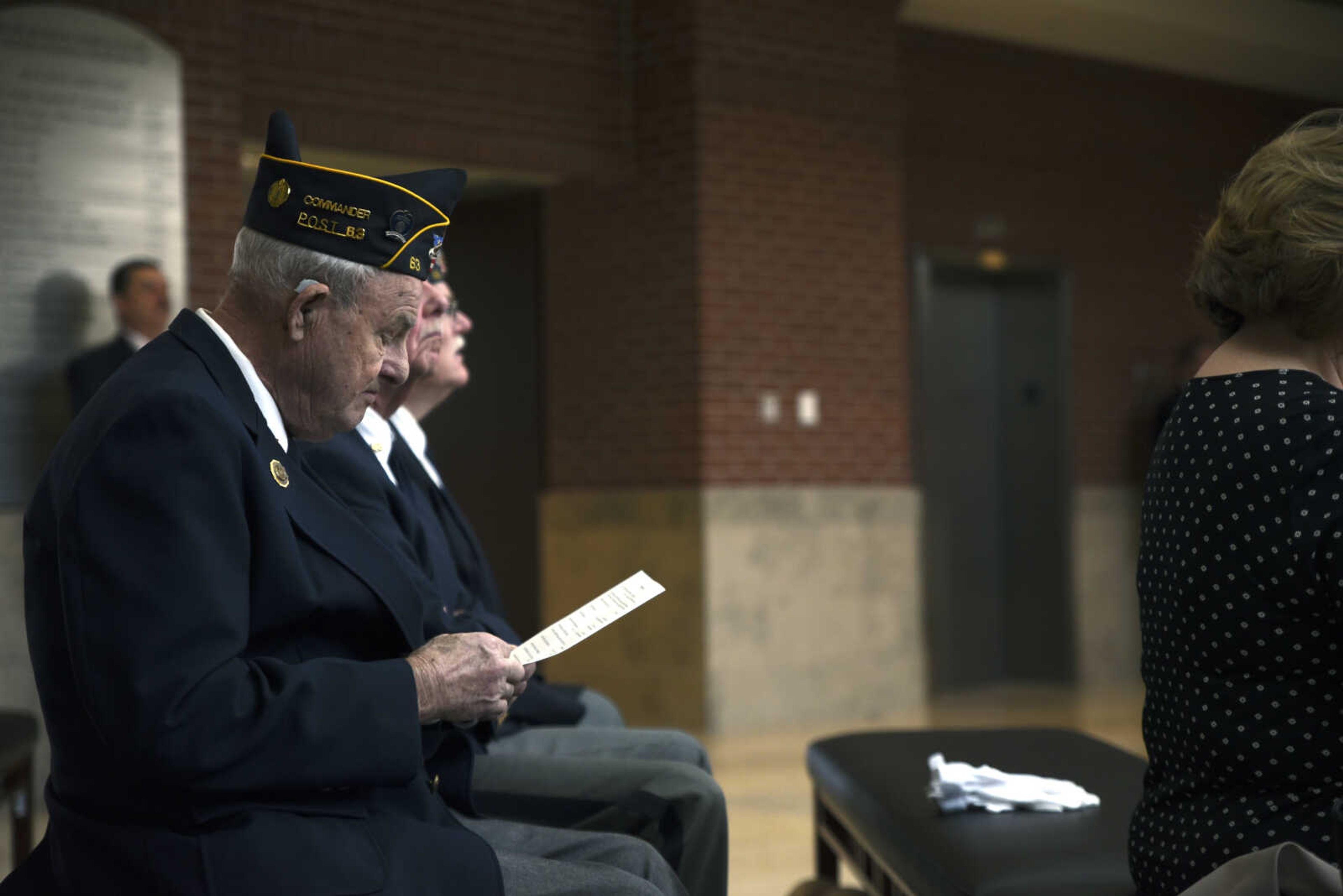 Monte Kyle of the Lewis K. Juden Post 63 of the American Legion looks at the program during the United States District Court Eastern District of Missouri Southeastern Division's naturalization ceremony on Friday, April 6, 2018, at the Rush Hudson Limbaugh, Jr., United States Courthouse in Cape Girardeau.