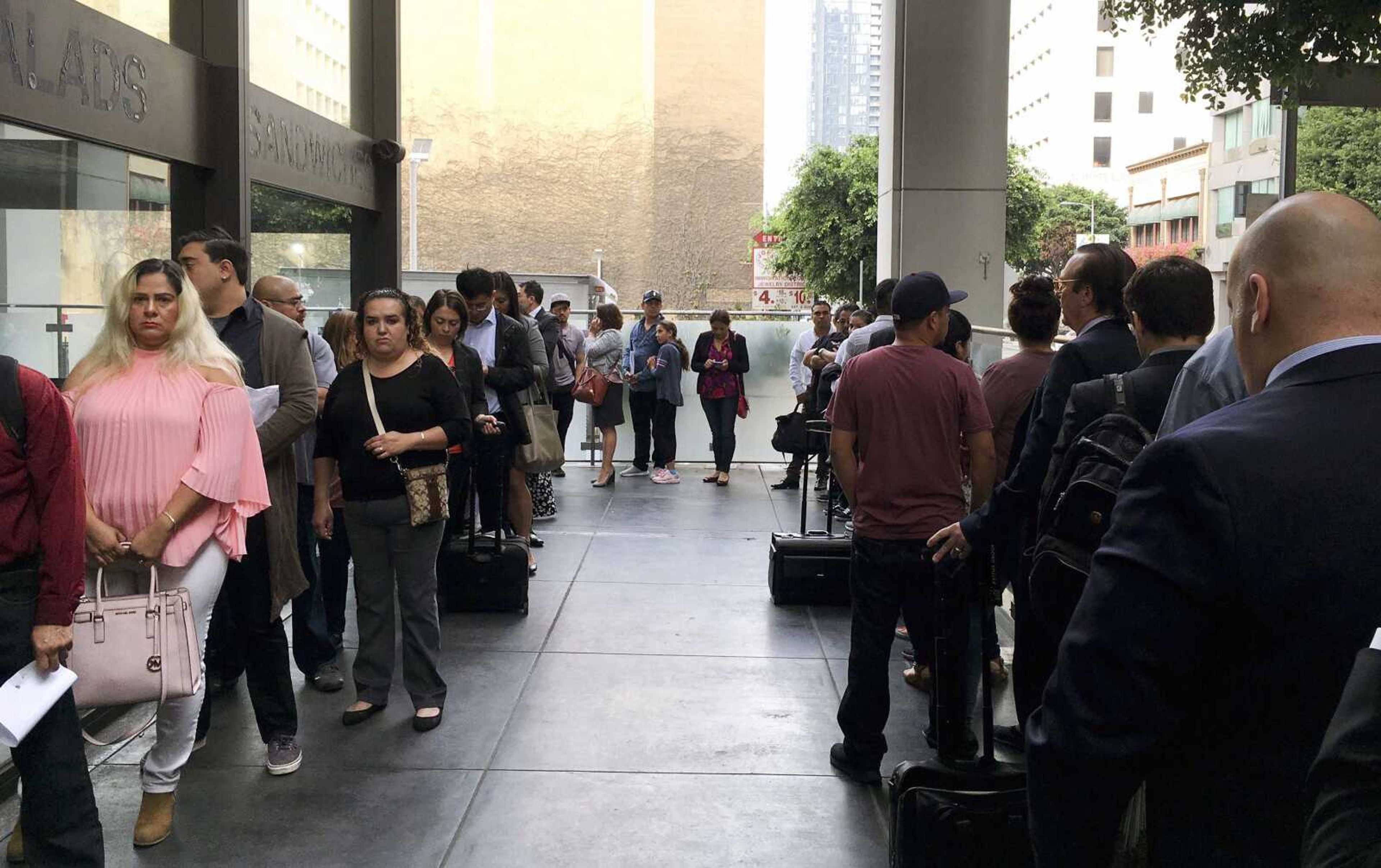 Immigrants awaiting June deportation hearings line up outside the building housing the immigration courts in Los Angeles. In recent weeks, immigration judges have been thrust into the center of the heated political controversy over how the Trump administration is handling the cases of mostly Central American immigrants caught on southwest border.