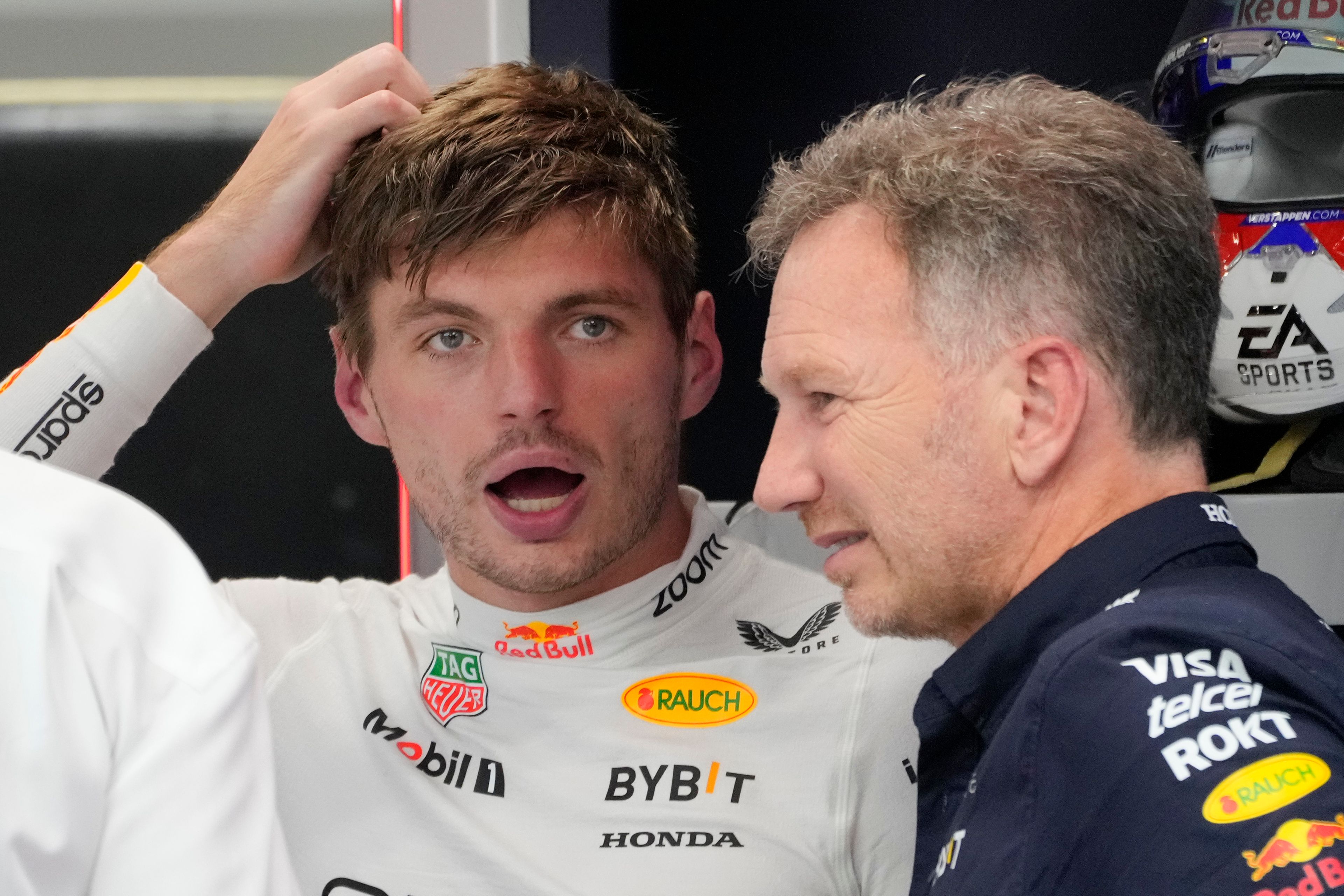 Red Bull driver Max Verstappen of the Netherlands, left, talks to team principal Christian Horner during the second practice session of the Singapore Formula One Grand Prix at the Marina Bay Street Circuit, in Singapore, Friday, Sept. 20, 2024. (AP Photo/Vincent Thian)