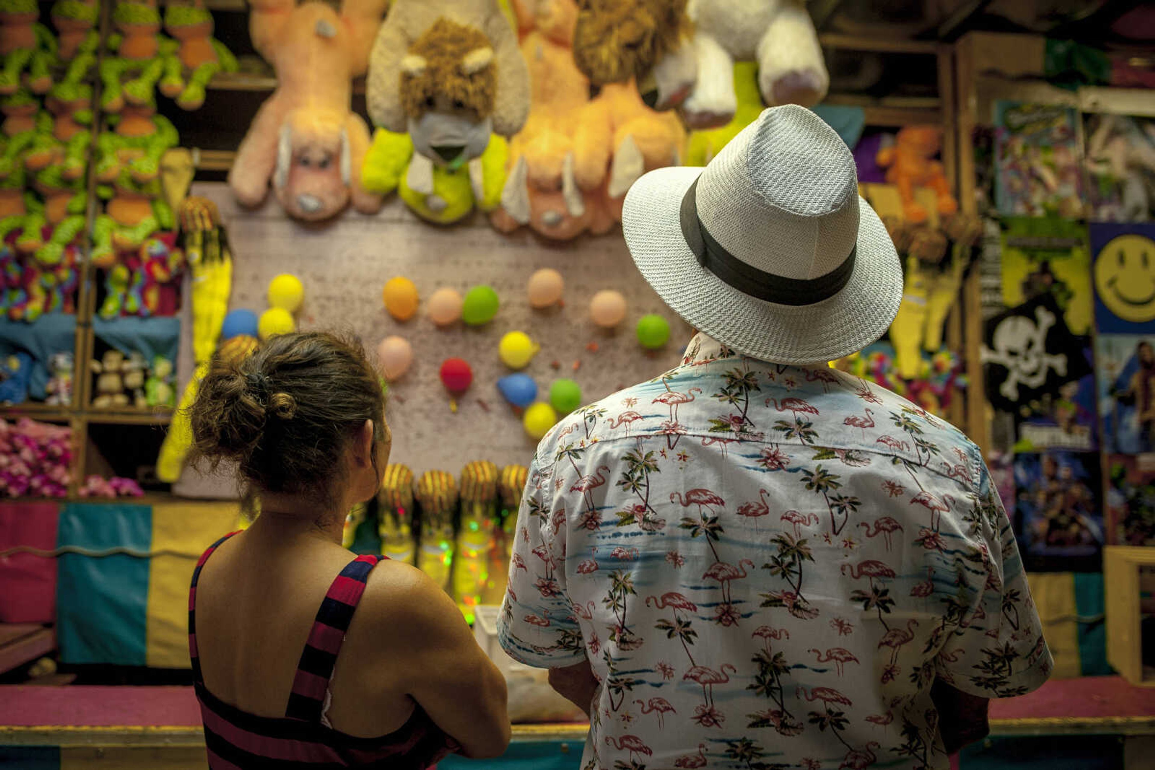 Nora and Gerry Roberson eye a dart game during the final day of Homecomers Saturday, July 27, 2019, in Uptown Jackson.